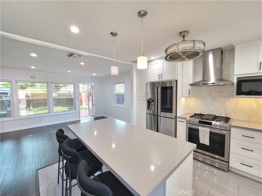 Welcome to this beautifully remodeled modern 2-bedroom + loft home offering a perfect blend of style, comfort, and outdoor living. The spacious loft includes its own private bathroom, ideal for use as a guest suite, home office, or creative space. Inside, an open-concept floor plan features a stunning chef’s kitchen with quartz countertops, a large center island, custom shaker cabinetry, stainless steel appliances, designer tile backsplash, and elegant pendant lighting that flows seamlessly into the bright living and dining areas. Enjoy the tranquil backyard retreat with a large brick patio, artificial turf, mature shade trees, and a covered gazebo lounge perfect for relaxing or entertaining. Additional highlights include recessed lighting throughout, upgraded bathrooms, dual-pane windows, beautiful wood and tile flooring, central air and heat, and modern finishes. Please note there is no garage, but ample driveway and street parking are available. Located on a quiet residential street close to parks, shopping, and dining, this property combines modern comfort with a serene neighborhood setting and is ready to welcome its next resident.
