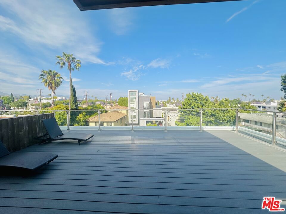 Ultra Modern, expansive two-level, 3 bedroom, 3 bath Weho Penthouse. This open concept, sophisticated townhouse offers a blend of indoor and outdoor luxury living. Entertain on your own oversized, private, rooftop deck, which offers forever views of the famed Hollywood Hills. Rooftop amenities include built in BBQ/outdoor kitchen. Upstairs features a spacious, primary bedroom en suite with front facing balcony, and walk in closet. Secondary bedroom with adjacent bathroom. On the main level there is one bedroom/office. Elegant, wide planked wood flooring throughout. A Chef's kitchen with quartz stone countertops, and top of the line appliances flows into an open, living area. Laundry closet tucked inside unit. Common lounge area for guests to meet up or for you to relax. Convenience is key with two side-by-side parking spaces in a secure, gated garage, and a bike room. Just minutes from the Sunset Strip/Whole foods/ Trader Joe's. Ready for you to explore the vibrant neighborhood. Provided unfurnished for you to bring your own finishing touches. A perfect blend of style and comfort. Don't miss this opportunity to treat yourself!
