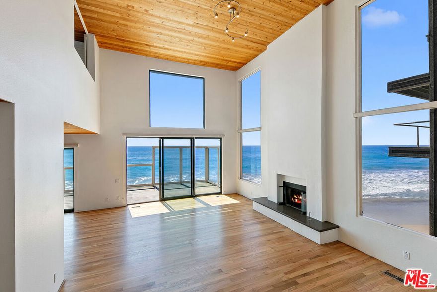 Experience beachfront living at its finest on one of Malibu's most picturesque stretches of sandy coastline. Located in a gated community with a private driveway, this home captures sweeping ocean and whitewater views, with vistas of the dramatic rock formations at El Matador Beach and far beyond. The living room is an entertainer's dream, featuring soaring ceilings, a wet bar with a wine fridge, a fireplace, and floor-to-ceiling windows gazing over the waves below. Sliding glass doors open to an expansive ~50-foot sun deck with 180-degree views of rocky outcroppings and passing sea life. The kitchen offers an island with bar seating, stainless steel appliances, and seamless flow into the dining area and den, with a second fireplace for cozy seaside evenings. Upstairs, the primary suite spans the front of the home with serene views in every direction. Two sets of sliding doors open to a private oceanfront balcony, while the en-suite bathroom features dual vanities and a walk-in closet. Two additional bedrooms, a full bathroom, and a powder room provide comfortable accommodations for family or guests. At the entry level, a private gate leads directly to the sandy beach and surf below, with nearshore reefs perfect for the ocean enthusiast. A fully enclosed courtyard ensures easy and secure access to the 3-car garage. For those seeking coastal bliss with views from sunrise to sunset, this retreat presents a rare opportunity to live in one of the best locations in all of Malibu. Available now for long-term lease.