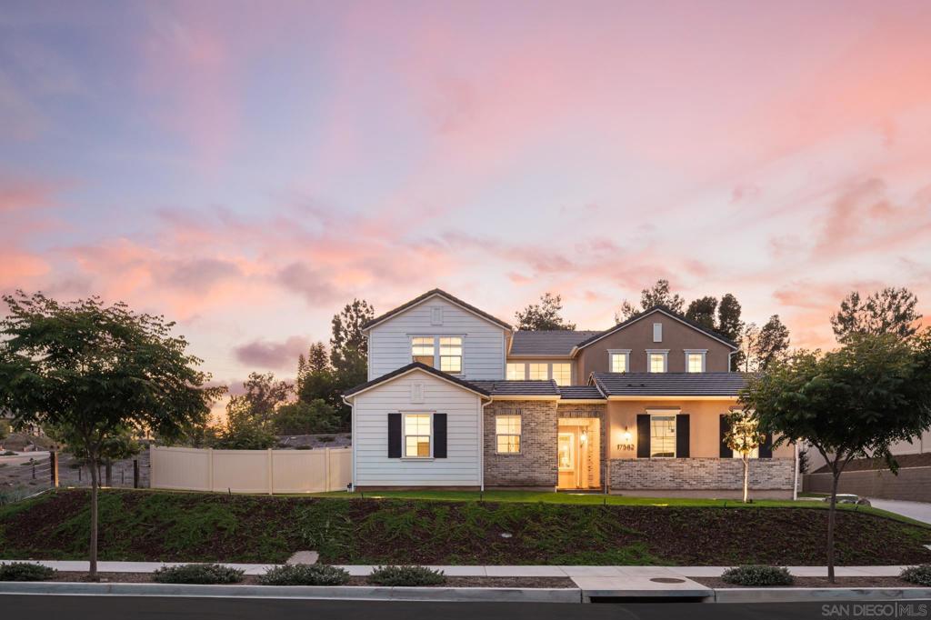 Welcome to your dream home in the prestigious enclave of The Farm—a rare opportunity to own a newly built 2023 masterpiece that seamlessly blends sophisticated design, cutting-edge technology, and family-friendly functionality. This 5-bedroom, 5.5-bathroom estate showcases the highly coveted “Homestead Residence Plan 1” floor plan, thoughtfully crafted for today’s modern lifestyle. Set within a serene and scenic neighborhood, this exceptional residence boasts Lennar’s Next Gen suite—an ideal multigenerational solution featuring its own private entrance, living area, kitchenette, bedroom, bathroom, and laundry. Whether you're hosting extended family or creating a private rental opportunity, the flexibility is unmatched. Inside, you'll find refined living spaces that exude style and warmth. French white oak flooring flows seamlessly through the expansive Great Room, dining area, and chef-inspired kitchen—complete with dual ovens, a built-in refrigerator, a prep island with custom quartz countertops, and both a walk-in pantry and a butler’s pantry. A seamless indoor-outdoor connection is achieved through oversized sliding doors that open to a private California Room and a spacious, beautifully landscaped backyard with a large, grassy area perfect for entertaining. The main level also features a private en-suite bedroom with a dedicated office. In contrast, the upper level features the luxurious primary suite, a media room, and two additional bedrooms, each with an en-suite bathroom. Energy-efficient and future-forward, the home includes a fully owned 4.4 kW solar system, a spacious 3-car garage with an extended driveway, and Lennar’s signature smart home technology. Ideally located near the top-rated schools of North Poway, residents enjoy exclusive access to The Farm's resort-style amenities, including hiking trails, community gardens, playgrounds, and a dog park. You'll also be moments from Lake Poway, Iron Mountain, renowned golf courses, and the upscale Rancho Bernardo Inn & Spa. This is more than a home—it's a lifestyle. Experience the perfect harmony of suburban tranquility, luxury living, and modern convenience.