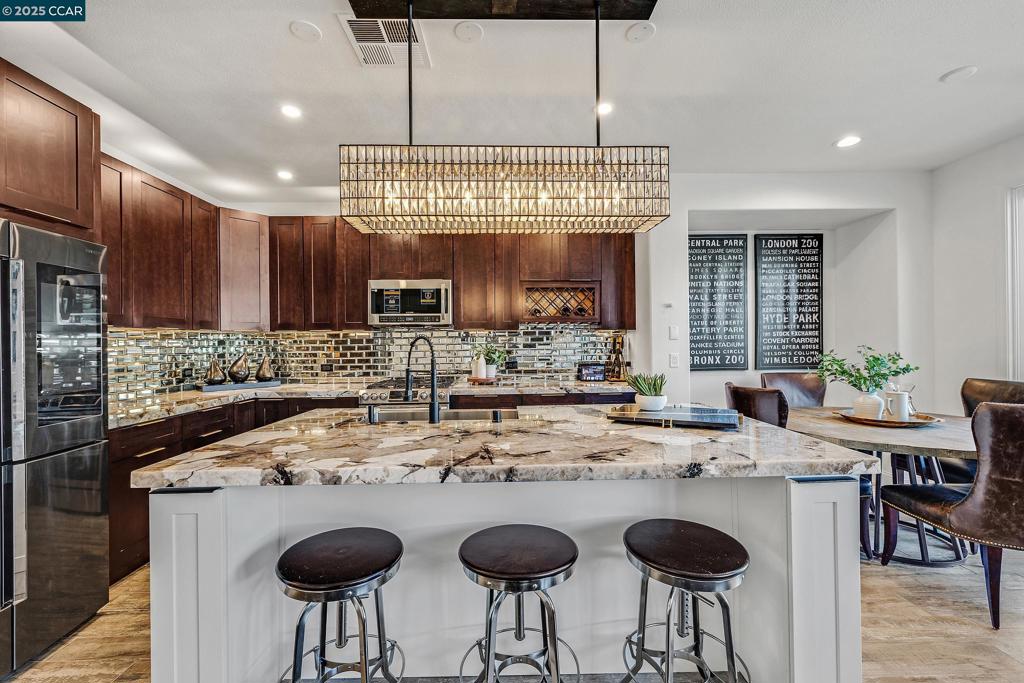Stunningly remodeled 4BD/3BA townhome in desirable Alamo Creek! Features include a main-level bedroom & bath, open-concept great room, and a gourmet kitchen with Patagonia quartzite island, Pottery Barn chandelier, custom cabinetry & top-of-the-line appliances. Spacious family room overlooking the backyard for California indoor-outdoor living. Enjoy your outside oasis with beautiful belgard paver patio with pergola, gorgeous deck with lighting, planters, and artificial turf. Luxurious primary suite upstairs with spa-like bath, soaking tub, walk-in shower, double vanity & custom walk-in closet. Two bedrooms & laundry with Samsung W/D complete the upper level. Other amenities: engineered hardwood & porcelain tile flooring, plantation shutters & blinds, LED lighting, illuminated mirrors, zero VOC paint, tandem 2 car garage & long driveway, smart home features & appliances including Samsung gas range, Samsung microwave with warranty, Samsung family hub refrigerator, hybrid hot water heater & "My Q" garage door with camera. Low HOA dues $236/month include exterior maintenance, hazard insurance & resort-style amenities: pool, clubhouse & gym. Top rated SRVUSD schools: Walk to Creekside Elem & Diablo Vista MS. Close to Blackhawk CC, shopping, dining & scenic trails.