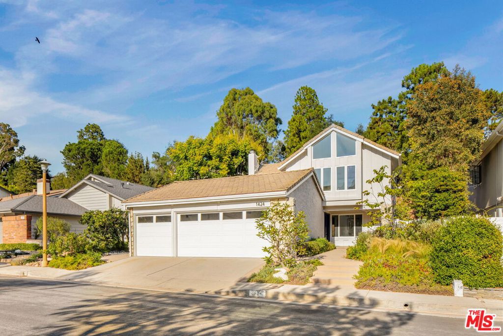 Set on a quiet cul-de-sac in the Palisades Highlands, this beautifully appointed two-level home offers the ideal balance of sophistication, comfort, and California lifestyle living. Enter to soaring ceilings and abundant natural light that fill the expansive living spaces. The formal living room impresses with vaulted ceilings, a gas fireplace, and a wet bar for entertaining, while the adjacent dining room sets the stage for memorable gatherings. Further on a separate family room flows seamlessly to the backyard through sliding glass doors, creating an effortless indoor-outdoor connection. At the heart of the home, the remodeled kitchen boasts custom wood cabinetry, stone countertops, premium Jennair appliances, a pantry, and a charming garden window. A casual breakfast area opens to a pergola-covered flagstone patio complete with a built-in BBQ--ideal for relaxed entertaining and alfresco dining. A sweeping curved oak stairway leads to the upper level, where all four bedrooms are thoughtfully appointed. The primary suite is a private sanctuary with beamed vaulted ceilings, dramatic picture windows framing the Santa Ynez Mountain Range, and exceptional storage with a walk-in closet plus two additional closets. The spa-like ensuite bath features dual vanities, a soaking tub, and a glass-enclosed tile shower. Three secondary bedrooms complete the level, one with a built-in desk ideal for a home office or study. Outdoors, a lush hillside backdrop ensures privacy with no rear neighbors. The backyard offers a grassy lawn, spacious open patios for lounging or dining, and the built-in BBQ for year-round entertaining. Additional highlights include a 3-car garage with direct entry, powder bath on the main level, and access to the Santa Ynez Recreation Center just around the corner--offering a 25-yard lap pool, kiddy pool, spa, playground, tennis and pickleball courts, gym, and game room. With hiking and biking trails of the Santa Monica Mountains nearby and just minutes to Palisades Village, this home captures the essence of California living.