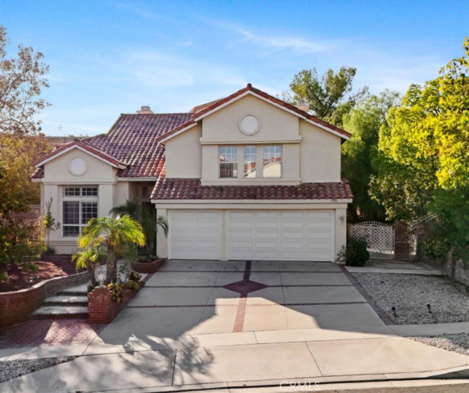 RV PARKING | 3–CAR GARAGE | DOWNSTAIRS BEDROOM | LOW HOA | Welcome to this beautiful 4-bedroom home nestled in one of Corona's most sought-after neighborhoods - Cantebria at The Corona Ranch. From the moment you step inside, you are greeted with abundant natural light, soaring ceilings, and upgraded flooring that flows through the open-concept design. The spacious Living Room showcases a striking double-sided fireplace, seamlessly shared with the Dining Room, creating the perfect atmosphere for gatherings. A second fireplace warms the inviting Family Room, ideal for cozy evenings. The Chef’s Kitchen is a true showpiece, featuring beautiful quartz countertops, an oversized island with seating for up to eight, stainless steel appliances, butler’s pantry, and generous storage. Indoor-outdoor living is at its best with direct access from both the Kitchen and dining areas to the backyard. Downstairs, a well-appointed Bedroom with gorgeous wood floors and a nearby Bathroom provides comfort for guests or multi-generational living. Upstairs, the Primary Suite includes an oversized walk-in closet, tile flooring, an entire wall of oversized windows, and an Ensuite Bathroom with a deep soaking tub, walk-in shower with bench, dual-sink countertop, and plentiful storage. Bedroom three delights with its own spacious private retreat and walk-in closet, while bedroom four also features a walk-in closet. A stylish hallway third bathroom with dual-sink countertop adds convenience. The separate laundry room offers excellent functionality with washer and dryer included, abundant cabinetry, and a convenient laundry chute and folding shelf. Outside, the oversized backyard is an entertainer’s paradise with a covered patio, raised seating area, basketball hoop, raised flowerbeds, and mature landscaping with the privacy that discerning buyers seek. Additional energy efficiency highlights include ceiling fans in multiple bedrooms and plantation blinds. Conveniently located near parks, shopping centers, Starbucks, Costco, restaurants, nearby golf course and more for tons of entertainment. Commuting is a breeze with quick access to the 15 Expressway, 91 Expressway, 241 Toll, 71, 215. This exceptional home is perfectly positioned for comfort and lifestyle! Welcome Home!