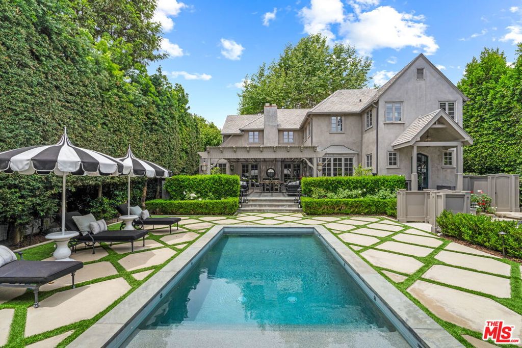 One of the most top quality homes in all of Sunset Square with a 2-story guest house, pool and resort like entertaining spaces. This impeccably renovated Traditional offers complete privacy as you enter through gates and under mature trees to the front door. First floor features: gracious entry opening to multiple rooms with oak floors, living room with coved ceiling, fireplace, cozy den / media room, formal dining room opening to large cook kitchen with top of the line appliances, eat-in banquette, large center island, laundry room and bathroom. 2 floor features: 2 bedrooms with en-suite full bathrooms, large primary suite with walk in closet, vaulted ceiling and views over the entire backward. Outdoor spaces for entertaining groups comparable to the finest resorts offering: Bluestone patio, outdoor kitchen, pool with baja shelf, huge cabana with bar and outdoor tv all wrapped in mature landscaping for ultimate privacy. 2-story guest house features: complete accordion door wall that opens to yard, kitchen with huge center island and flex space that includes full bathroom with upstairs offering an office space with vaulted ceilings. Just blocks to the world class amenities of: The Sunset Strip, West Hollywood, Runyon Canyon hiking trails and more.