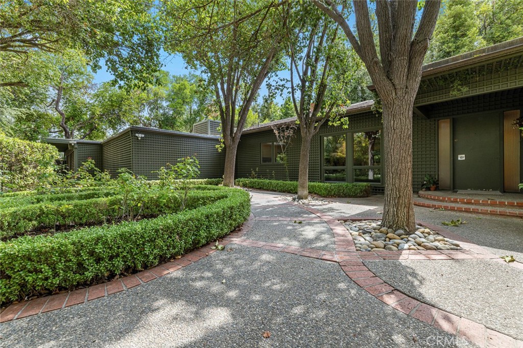 Discover a one-of-a-kind opportunity in Old Fig Garden just one home away from the iconic Christmas Tree Lane! This special 3 bedroom, 2 bath single-story residence with a versatile den AND an oversized sunroom has never been listed before. Purchased from Patricia Hopper, the renowned artist chosen to design Storlyand in Roeding Park and fulfill the vision for the park's concept, this home carries a remarkable history and features unique custom touches by Pat herself. From the striking cream wall sculpture to the unique wet bar, tranquil outdoor fountain and tile floor, artistic detail and character are woven throughout this amazing property.
The floor plan is spacious, inviting, and perfect for entertaining! The grand living room showcases soaring vaulted ceilings, beautiful beam detail, and a stunning fireplace wall that is perfect for cozy nights or hanging out in style. A large separate dining room is lined with picture windows, flooding the space with natural light and creating an ideal setting for gatherings.
The home's layout continues to impress with a flexible den, perfect for an office, playroom, library, or gaming room- an incredible bonus for modern living. Even more exceptional is the oversized sunroom, offering abundant storage and endless possibilities as a creative studio, home gym, or simply a bright retreat to enjoy year-round.
The primary suite is generously sized and features a huge walk-in closet and private ensuite bath. With brand-new carpet and fresh interior paint, the home is move-in ready and brimming with possibility. Every room is generously sized and the two-car garage plus an enclosed storage space is sure to meet all of your needs.
Set in one of Fresno's most beloved neighborhoods, this home offers not only a spectacular location but also the chance to celebrate the upcoming holiday season in the heart of it all.
Don't miss your opportunity to own this rare piece of Old Fig Garden history!
Bed, bath and fireplace count differ from tax record. Buyer to verify.