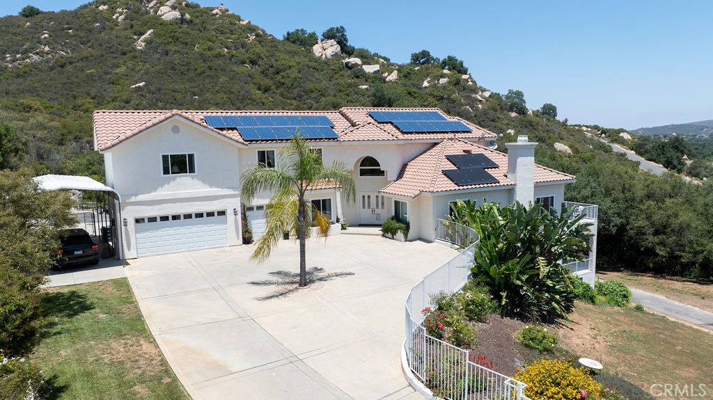 Spectacular forever views from your own private villa in the Hills of Murrieta. Tucked away just fifteen minutes to the 15 Freeway, Easy access 1.5 hours to either Orange County, San Diego and multiple other locations. Surrounded by rolling hills, fields and vineyards, multiple hiking, and riding trails.
Rarely does a property like this come on the market, Views from every room and even your own private creek and oak grove – a perfect get away or tranquility and relaxation. Room for pool (plans available)and entertaining areas. The property is set up for extended family or guests offering three separate units or, just use it as one home. Perfect for in-laws, grown kids and more. Enter through your private gated entrance to motor court, three car garage, room for rv/boat. Double entry doors lead into large two-story foyer. Commanding circular staircase leads to sumptuous Primary Bedroom, expansive bath area and walk in closets, watch the twinkling evening lights, moon and listen to the exotic birds and nature all around you. Watch the mist come in and fade away, lovely ocean breezes keep the temperature perfect. Kitchen with center island, two sinks and all the bells and whistles. Beautiful formal dining room for entertaining, large open great room with cozy fireplace, wood floors flooded with sunlight and expansive deck for entertaining and outdoor dining. Two additional kitchens and 6.5 bathrooms There is a ground floor bedroom and large office. Beautiful grounds encompass picnic areas under the oaks whilst you watch your own bubbling stream. Lots of room for gardening. Enjoy the amenities of two gated entrances, three Tesla back up batteries, paid for solar panels, your own well, Springwell water filtration system, newer septic tank, 5,000-gallon steel water storage tank, Bonded Frontier internet and Tesla Starlink (both transferable)and a domestic waste composter to name a few. Plus, multiple refrigerators, and other appliances, some wood flooring and more.