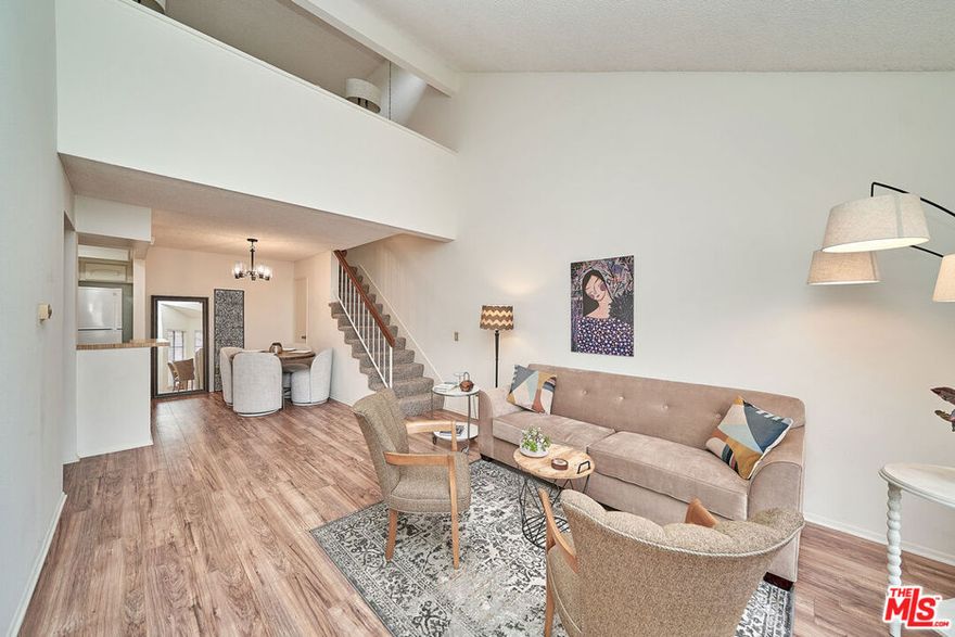 Move-in ready and recently refreshed! Welcome to your new home in the highly sought-after Westside community of Fullerton. This stylish upper-level unit offers a bright, open, and functional split-level floor plan. The spacious living area features soaring ceilings, fresh updates, Ice cold central AC and heat,  plenty of natural light, flowing seamlessly into the dining space and a well-designed galley kitchen, perfect for modern living and entertaining.  The main level includes a comfortable bedroom, a full bathroom, and in-unit laundry for everyday convenience. Upstairs, you'll find a versatile loft that can serve as a second bedroom, home office, or den, complete with an oversized walk-in closet, attic storage, and a half bath. Step outside to the large private patio, ideal for relaxing or enjoying sunset views. This move-in ready home also includes a dedicated covered carport. The well-maintained community offers resort-style amenities including two sparkling pools, a spa, playground, BBQ area, and beautifully landscaped grounds with ample guest parking. The HOA covers water, trash, exterior insurance, and building maintenance. Conveniently located near Clark Regional Park, Los Coyotes Golf Country Club, shopping, dining, public transportation, and top-rated schools, The Westside Community is the perfect blend of comfort, style, and location!