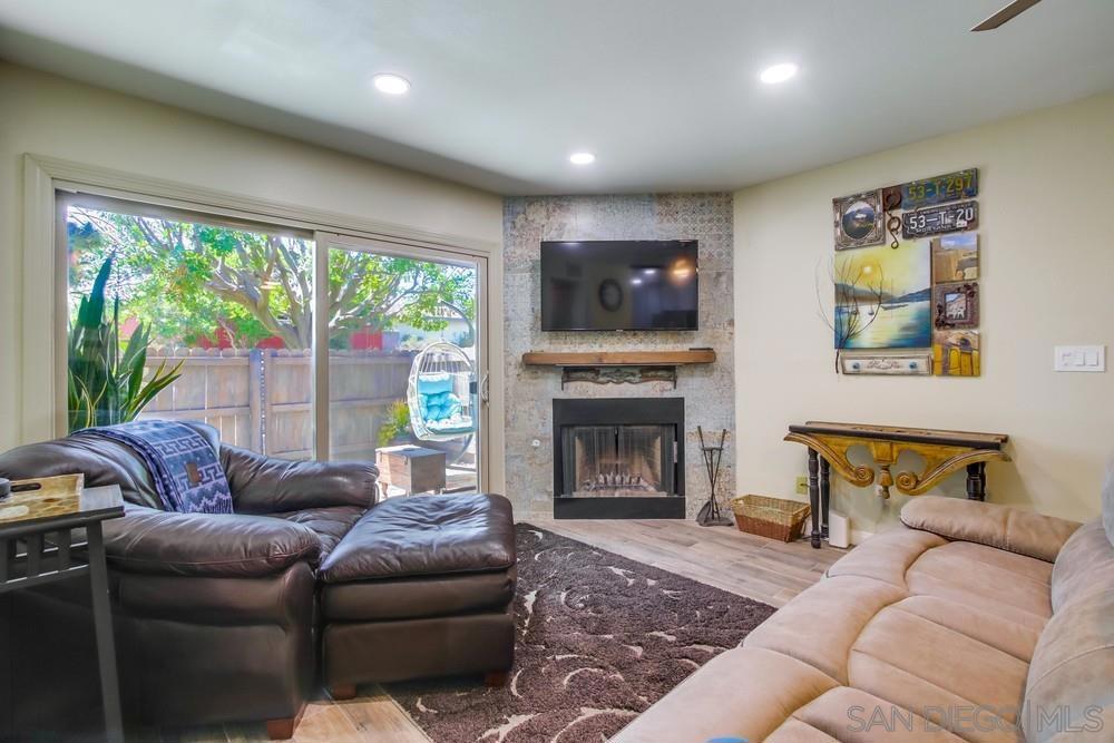 Welcome to the lowest price in the area beautifully remodeled single-level 2-bed, 2-bath condo with an attached garage & in unit full sized W/D. This home perfectly blends style, comfort & convenience. From the moment you approach the front door, you're greeted by a tranquil, Zen-inspired garden setting. Inside, you'll find an inviting open layout with wood-look tile flooring throughout, soft contemporary paint tones, & a stunning floor-to-ceiling custom tiled fireplace that anchors the living space. The kitchen features a modern mix of black & stainless steel appliances, including a refrigerator, accented by granite tile countertops & a custom backsplash. A cozy corner bar offers space for casual dining, while there's also plenty of room for a full dining table. Enjoy thoughtful upgrades like recessed lighting, ceiling fans, & AC. The oversized primary suite is a true retreat, complete with a lounging area, a walk-in custom closet & a spa-like bathroom featuring dual sinks, new cabinetry & modern fixtures. The secondary bedroom is equally versatile with a built-in Murphy bed & built ins. The second bathroom mirrors the stylish master design. Additional highlights include a full-size in-unit washer & dryer with built-in storage, new windows & sliding door, & a large private patio oasis with partial cover, custom tile, and full fencing. The oversized one-car garage is fully finished with a workspace and opener. Enjoy resort-style amenities in the community with a pool, spa & lounging area all within walking distance to favorite local restaurants and with easy freeway access.