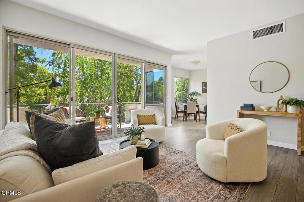 Ideally positioned in one of Pasadena's most desirable neighborhoods, just moments from Caltech and the vibrant South Lake Avenue Shopping District, this beautiful, bright 2 bedroom, 2 bathroom top-floor condo provides the perfect balance of comfort, style, and convenience.The large living area provides exceptional flexibility, with enough room to comfortably accommodate both everyday living and a dedicated work-from-home space. Whether you need an area for focused productivity, a creative nook, or simply room to spread out, the open-concept layout easily adapts to your lifestyle. High ceilings and oversized dual- pane sliding doors fill the space with natural light and open onto a spacious patio surrounded by lush greenery and stunning views of the San Gabriel Mountains.The kitchen is thoughtfully designed with a peninsula for casual dining and comes equipped with appliances and quality countertops. It opens to a more formal dining area with treetop views from both windows. Down the hallway are two generously sized bedrooms, each with ample closet space and dual-pane windows, along with two well appointed bathrooms, one featuring a full-sized tub and new flooring.Freshly painted and move-in ready, the home also includes wood-style flooring and two skylights. The property has one covered parking space and access to multiple overflow parking spots for owners. The beautifully landscaped complex features a sparkling pool, spa, and barbecue area, offering an idyllic resort like atmosphere year round.HOA dues cover not only common area maintenance, but also added conveniences such as trash, earthquake insurance, hot water, and electricity for the cooling system, helping to manage monthly utility costs.With its unbeatable location near Erewhon, Trader Joe's, fitness studios, and restaurants, as well as convenient access to major freeways and public transit, this home offers the ideal Pasadena lifestyle.