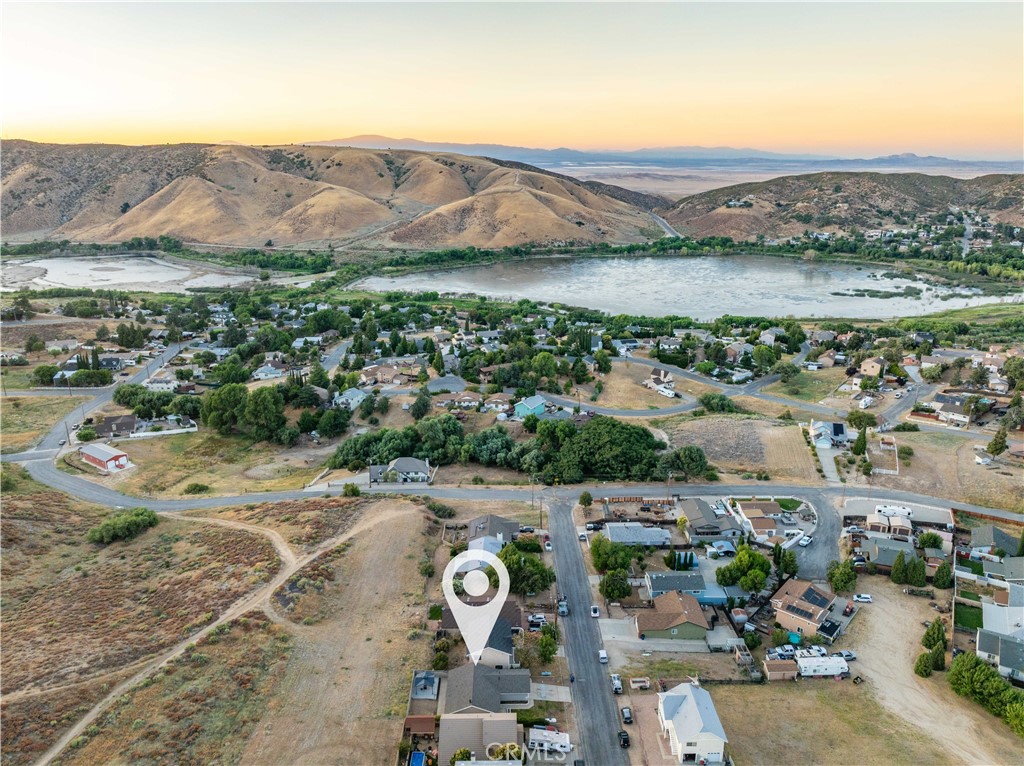 ***LIVE BEAUTIFULLY*** Upgraded Lake Hughes Gem! Over $51,000 in Recent Improvements! Welcome to your perfect starter home nestled in the peaceful community of Lake Hughes! This charming 3-bedroom, 2-bathroom residence has been thoughtfully updated with over $51,000 in recent upgrades and amenities, offering a move-in ready experience with modern touches throughout. Step inside to discover NEW windows, NEW flooring, and NEW baseboards, complemented by fresh interior paint that creates a bright and inviting atmosphere. The cozy rockwall fireplace adds a warm, rustic charm—perfect for relaxing evenings. You'll also find modern ceiling fans and stylish lighting fixtures throughout, enhancing both comfort and design. The renovated bathrooms feature contemporary finishes, including a luxury primary suite complete with a stone-tiled shower and new mirror. The modern kitchen is a true showstopper with sleek quartz countertops, stainless steel appliances, and clean-lined cabinetry—ideal for home chefs and entertainers alike. Enjoy the outdoors in your private backyard, highlighted by a pergola that provides both shade and seclusion, perfect for weekend lounging or gatherings. Don't miss this opportunity to own a beautifully updated home in the tranquil setting of Lake Hughes. Whether you're a first-time buyer or looking for a serene retreat, this property checks every box!