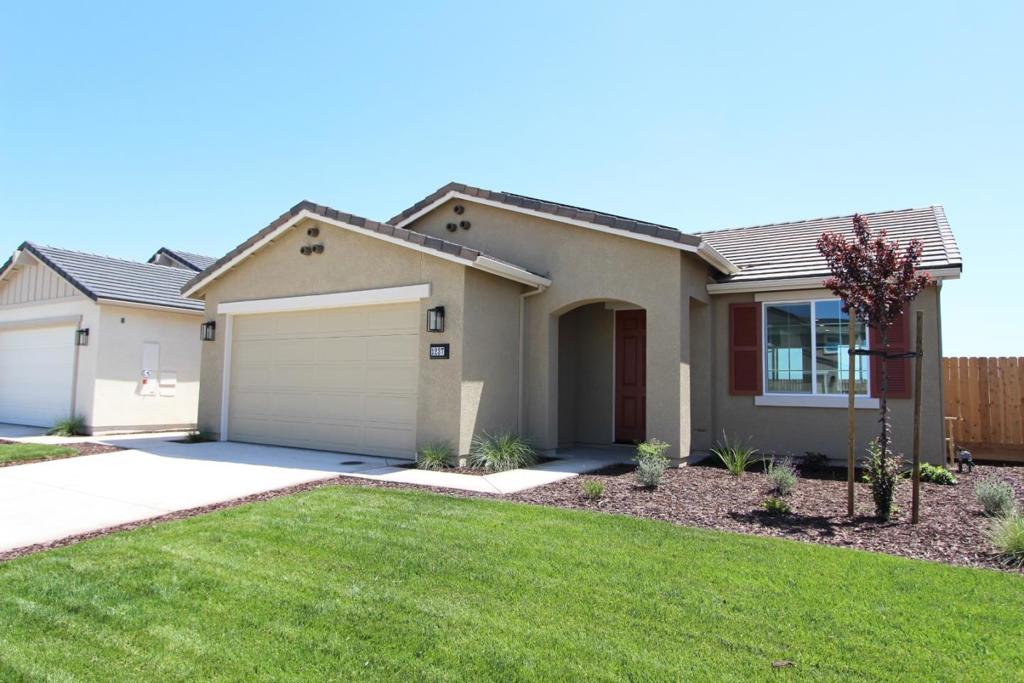 Welcome to this beautifully maintained 3-bedroom, 2-bathroom home featuring a spacious 2-car garage and an inviting open-concept layout. Inside boasts a mix of carpet, tile, and laminate flooring that adds both comfort and style. The heart of the home is the modern kitchen, complete with sleek white quartz countertops, custom stained shaker style cabinets, and all appliances included, making meal preparation a joy. A dedicated laundry room with washer and dryer offers added convenience. Step outside to a beautifully landscaped backyard, perfect for relaxing or entertaining. With its thoughtful updates and pristine condition, this home is truly move-in ready
