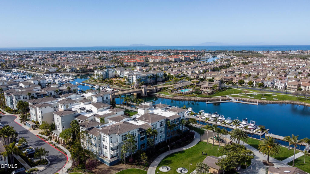 Single level living in beautiful Seabridge waterfront community. This light and bright 2-bedroom 2-bath condominium is a perfect home or weekend retreat featuring 1700 square feet of open living space with water views from living room windows and balcony overlooking the Marina. Thoughtfully updated throughout with base and crown molding, tile flooring in entry, baths and kitchen, carpet in living area and bedrooms, privacy window treatments and plantation shutters, ceiling fans, phantom screens on doors, mirrored wardrobe doors, and walk-in shower tub in guest bath. Kitchen has updated white cabinetry with custom pullouts, stone counters, kitchen island breakfast bar and casual breakfast nook with bench seating. Built-in cooking appliances include double ovens, gas range top, microwave and refrigerator. Just off the kitchen is a dining area open to the living room with fireplace and views toward the marina. A spacious balcony is accessible from both the living room and primary suite to enjoy the gorgeous Southern California Sunsets. Your primary ensuite features a walk-in closet, soaking tub, separate tiled shower, two separate sink cabinet areas and a private water closet with custom cabinets. Coded access doors for parking and front entry to the building. Enjoy the outdoor area in your building where you can relax by the water and enjoy a community terrace equipped with lounge chairs, water feature, BBQ area and a fireplace to indulge in the marina lifestyle. You also have access to all of the wonderful Seabridge amenities including a temperature-controlled heated pool, spa, clubhouse, gym, meditation/pilates room, caterers' kitchen, reading room with fireplace, outdoor fire pit and bbq area with plush lounge chairs, play area for children, and walking paths around the Seabridge and adjoining communities. Conveniently located between L.A. and Santa Barbara. Come live the dream of the harbor lifestyle in the Channel Islands Marina where you can boat to the islands or the harbor and enjoy the many restaurants and shops.