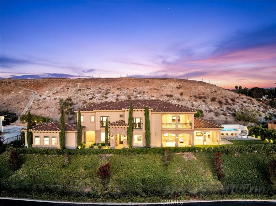 **Luxurious Living with Breathtaking Views in Exclusive Victoria Woods - With easily one of the best views in Inland Empire from every corner of the home! This prominent hillside enclave, composed of only 6 custom-crafted residences, offers luxurious living with breathtaking 180-degree city light and mountain views. Enjoy a prime location with easy access to Downtown Riverside and its array of amenities.

**Property Highlights:**

-Main house- Features a unique and modern floor plan with 5 bedrooms and 5 bathrooms, designed for seamless living. The main level boasts a great room with a cozy fireplace, a separate formal dining room, and a gourmet island kitchen equipped with top-of-the-line appliances and a spacious walk-in pantry. The main level primary suite is situated privately at the end of a gallery hall, providing a serene retreat.

-Upper Level-Discover an additional family room/media room with access to a large lanai, offering stunning views. Three secondary bedroom suites, each with adjoining bathrooms, and a second primary suite nearly identical to the main level suite, also with lanai access, complete this level.

 -Detached ADU- Perfect for multi-generational living or as a private home office for remote work, this detached unit includes a kitchenette and private bath.

 -Amenities-Immerse yourself in a backyard that boasts of one of the best sunset views in Inland Empire with a state-of-the-art elevated salt-water pool and sheer descents all app-controlled with built-in gas fire pit.  The home also includes a balcony, oversized 3-car garage, game room, and convenient upper-level laundry room. The superior quality of construction and top of the line amenities are endless- high ceiling with double crown molding throughout, energy efficient Air-scape system, built-in speaker system, full home water purifying and softening system, custom made KitchenAid appliances with double oven, recessed LED lighting throughout:  Oversized garage with epoxy flooring and loads of built in cabinetry; the list goes on!   The grounds are beautifully landscaped with mature trees and low-maintenance materials, offering a peaceful and private setting. Bursting with highly upgraded finishes throughout and presented in turn-key condition, this property represents the epitome of luxurious and comfortable living.  Make this exquisite home yours and experience the best of Riverside living in the exclusive Victoria Woods enclave.