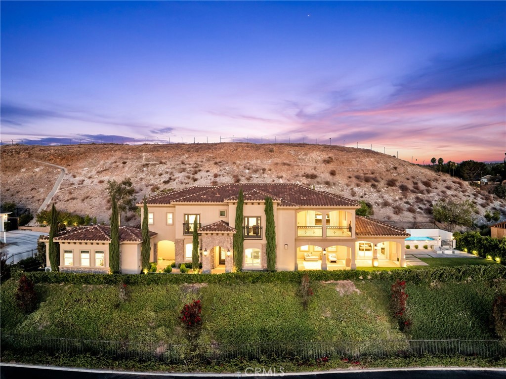 **Luxurious Living with Breathtaking Views in Exclusive Victoria Woods - With easily one of the best views in Inland Empire from every corner of the home! This prominent hillside enclave, composed of only 6 custom-crafted residences, offers luxurious living with breathtaking 180-degree city light and mountain views. Enjoy a prime location with easy access to Downtown Riverside and its array of amenities.
**Property Highlights:**
-Main House- Features a unique and modern floor plan with 5 bedrooms and 5 bathrooms, designed for seamless living. The main level boasts a great room with a cozy fireplace, a separate formal dining room, and a gourmet island kitchen equipped with top-of-the-line appliances and a spacious walk-in pantry. The main level primary suite is situated privately at the end of a gallery hall, providing a serene retreat.
-Upper Level-Discover an additional family room/media room with access to a large lanai, offering stunning views. Three secondary bedroom suites, each with adjoining bathrooms, and a second primary suite nearly identical to the main level suite, also with lanai access, complete this level.
-Detached ADU- Perfect for multi-generational living or as a private home office for remote work, this detached unit includes a kitchenette and private bath.
-Amenities-Immerse yourself in a backyard that boasts of one of the best sunset views in Inland Empire with a state-of-the-art elevated salt-water pool and sheer descents all app-controlled with built-in gas fire pit. The home also includes a balcony, oversized 3-car garage, game room, and convenient upper-level laundry room. The superior quality of construction and top of the line amenities are endless- high ceiling with double crown molding throughout, energy efficient Air-scape system, built-in speaker system, full home water purifying and softening system, custom made KitchenAid appliances with double oven, recessed LED lighting throughout: Oversized garage with epoxy flooring and loads of built in cabinetry; the list goes on! The grounds are beautifully landscaped with mature trees and low-maintenance materials, offering a peaceful and private setting. Bursting with highly upgraded finishes throughout and presented in turn-key condition, this property represents the epitome of luxurious and comfortable living. Make this exquisite home yours and experience the best of Riverside living in the exclusive Victoria Woods enclave.