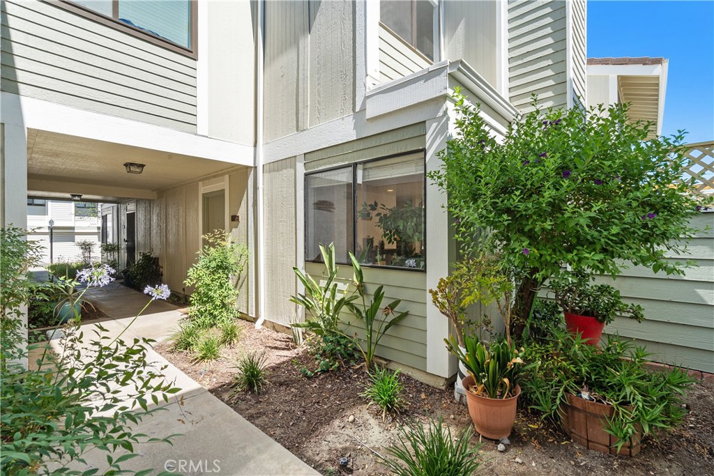 Light-filled interiors, stylish upgrades, and private outdoor space—this updated 2-bedroom, 1.5-bath townhome offers turnkey living in a central Canyon Country location. Inside, new Luxury Vinyl flooring runs throughout both levels, including the stairs, giving the home a clean, modern feel. The main floor includes a spacious living room and dining area, positioned next to a large glass slider that opens to an oversized fenced patio with new sunshades—perfect for outdoor dining or relaxing. From here, enjoy direct access to the attached 2-car garage, a practical and rare convenience. The kitchen has been thoughtfully updated with rich wood cabinetry, a deep stainless steel double sink, and matching stainless steel appliances including a refrigerator, stove, microwave, and dishwasher. A convenient half bath and an in-unit laundry area complete the downstairs layout. Upstairs, two generously sized bedrooms share a full bathroom. The primary bedroom features a private vanity area with direct access to the bath, offering comfort and functionality. Other recent improvements include a newer power panel and the removal of popcorn ceilings. Natural light pours in throughout the home, and windows overlook serene greenbelt views that add to the peaceful setting. The Canyon Village community offers residents access to multiple pools, tennis courts, and well-maintained green spaces. Located near shopping, dining, and major commuter routes, this move-in-ready townhome is ready to welcome you home.