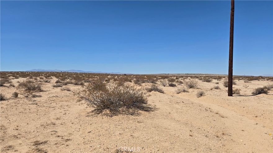 No address has yet been assigned to this property. It is located 330' west of Friendship Ave, on a dirt road travelling east and west where Mars Rd would be if it came through from the west. The lot is a 2.5-acre property, level, with a couple of other properties nearby. There are SoCal Edison lines travelling north and south about 15' inside the east property line. The Twentynine Palms Water District states that a water main is located on Friendship Ave, and a water meter for this property can be purchased from them and placed in the easement on Friendship. The Buyer would be responsible for plumbing the 330' from that point to the property itself. There are easements in place for this, according to the Water District. Any Buyer should verify costs for the meter and the plumbing by contacting the Twentynine Palms Water District. They are very helpful. All in all, if you're looking for a spot to build your desert retreat or full-time home, this property offers one of the simpler builds due to the availability of utilities, making it an ideal location for your project. Come check it out!