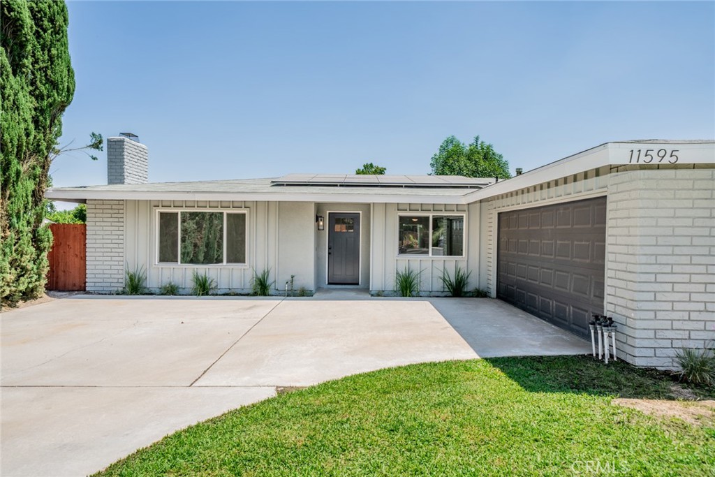 Experience the best of Southern California living in this beautifully updated 4-bedroom, 2-bath ranch-style home on a generous 9,310 sq ft lot in desirable Loma Linda. Built in 1974 and thoughtfully modernized throughout, the 1,760 sq ft interior features a bright open floor plan ideal for everyday living and entertaining. Vaulted ceilings soar above the spacious living room, bathed in natural light from picture-windows overlooking the yard.
The heart of the home is the sleek, all-white kitchen, appointed with quartz countertops, stainless-steel appliances, abundant cabinetry, and a center island perfect for morning coffee or casual meals. Adjacent, the formal dining area flows seamlessly into the living space, while a cozy family room offers the perfect media or game-night retreat.
Retreat to any of four generously sized bedrooms, each offering ceiling fans, plush carpeting, and serene garden views. The two tastefully renovated bathrooms boast modern fixtures, frameless glass showers, and bright, spa-inspired finishes.
Step outside to your private oasis: a covered patio overlooks sparkling pool and spa, surrounded by lush landscaping and mature fruit trees, an entertainer’s dream for barbecues or peaceful afternoon relaxation. A large, attached two-car garage plus a separate workshop/storage area provides room for hobbies and gear.
Energy-savvy buyers will appreciate the fully paid-off solar panel system, dramatically lowering monthly bills and ensuring years of eco-friendly comfort. Located just minutes from parks, top-rated schools, shopping, and freeways, 11595 Poplar Street delivers the perfect blend of modern convenience and classic California charm. Your forever home awaits!