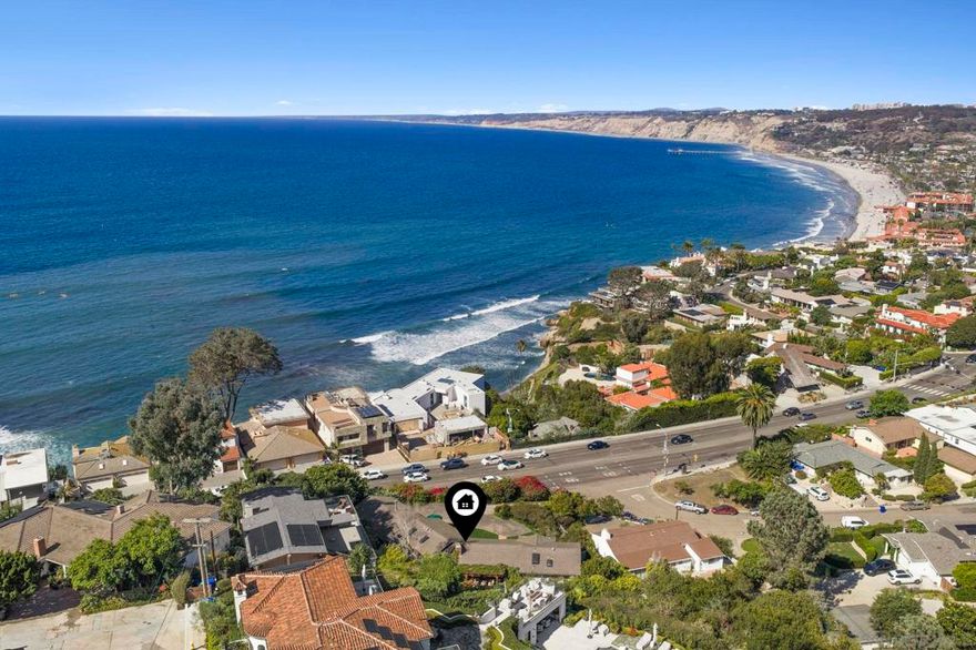 Stunning, far-reaching views of the Pacific, La Jolla Shores, and northern coastline are found in this welcoming and light-filled single-level home in La Jolla. Beautifully maintained indoors and out, with views from nearly every room, this beloved home offers multiple fireplaces, an eat-in galley kitchen, step-down family room with terrace, and abundant storage. Pitched wood slat ceilings add volume to living spaces without sacrificing the home’s inviting aura. The picture-perfect and lush backyard is bordered by mature greenery,  a grassy lawn, patio and trellis and offers both privacy and views through to the Pacific. Timeless in design and blessed with spectacular views, the home also features easy access to the Village, beaches and freeways. Enter driveway off Amalfi Street.