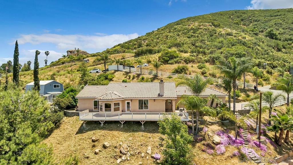 Unmatched Views & Single-Story Living in Ramona Perched on 1.25 acres with sweeping mountain views, this beautiful single-story home offers the perfect blend of space, comfort, and serenity. With 3 bedrooms, 3 bathrooms, and 1,911 sq ft of well-designed living space, you’ll find room to relax, entertain, and truly enjoy the peaceful lifestyle Ramona is known for. Step into a welcoming living room with a cozy fireplace—perfect for cool evenings or creating that perfect ambiance. The spacious kitchen offers ample cabinetry and storage, ideal for everything from everyday meals to weekend gatherings. Outside, the large back deck is your front-row seat to panoramic mountain views—whether you're sipping morning coffee, unwinding at sunset, or hosting friends for a BBQ. With PAID SOLAR, an EV charger, and a whole-house water filtration system, this home is as efficient as it is inviting. Located just minutes from town, you'll enjoy the quiet of the countryside without sacrificing convenience. Don’t miss your chance to own this view-filled retreat in the heart of Ramona!