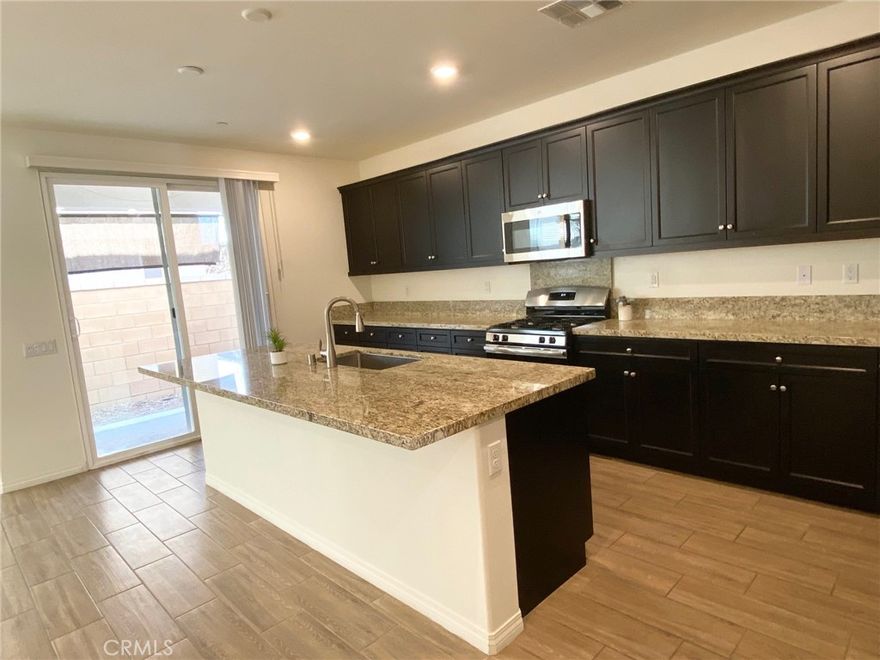 Beautiful Single-Family Home located in a very desirable Ontario Ranch Area. It contains 4 bedrooms, 4 bathrooms and was built in 2018. END UNIT, light and airy, open floor plan is ideal for gatherings and entertainment! The kitchen is a chef’s delight with beautiful, upgraded granite counters and stainless-steel appliances including range, oven and microwave oven. There is a center island with space for casual dining. A guest bedroom suite is conveniently located on the first floor. Upstairs there is an open/huge loft area ideal for an upstairs office/media room/playroom. Additionally there are 3 upstirs bedrooms including a master bedroom suite with a large bathroom. There is a direct access two-car garage, driveway and backyard.
 Great community amenities include community pool, spa, clubhouse and park. Close to shopping, Ontario Mills Mall, easy FWY15 and FWY60 access. Must see!