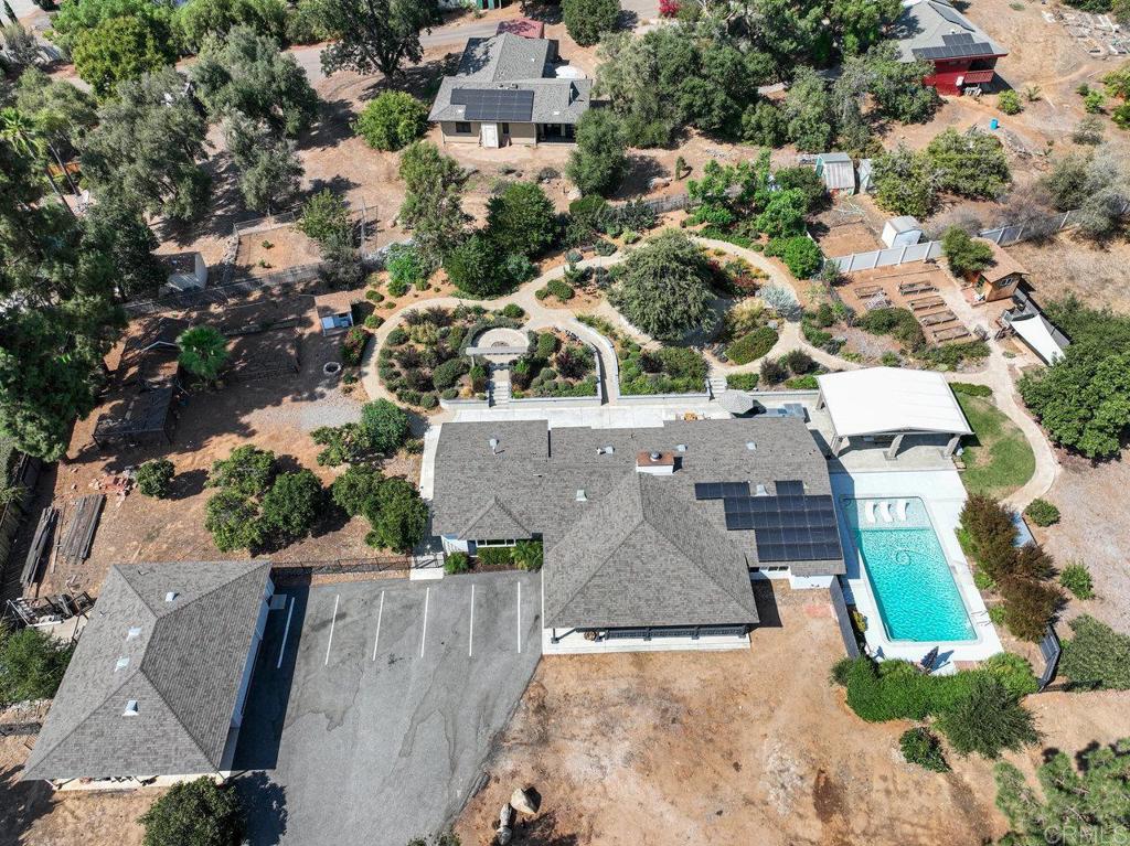 A private one-of-a-kind Horizon Hills gem! This gated ranch-style home spans 2,676 sq ft and features 4 spacious bedrooms and 3 bathrooms, offering a thoughtfully designed layout ideal for both everyday living and hosting guests. A large light-filled, updated kitchen opens to the incredible backyard gardens and patio entertaining. Outside, immerse yourself in vibrant blooming flower gardens and walking trails that have been professionally landscaped. The backyard is an entertainer’s dream—complete with a sparkling pool with lounge chairs and bubblers, a huge covered patio, built-in grill, bar area, and outdoor fireplace—perfect for evening gatherings or relaxing weekends. The yard also includes, planter boxes, potting shed, chicken coop, citrus orchard and plenty of opportuunity and space to build a future ADU. A large oversized 2-car garage offers ample storage, workshop area and includes its own half bathroom—a rare and convenient bonus. Solar is a 5kW in size, power purchase agreement, and a newer upgraded septic system. This unique property offers privacy, space, and comfort in one of the area's most desirable neighborhoods, close to schools, shopping and more.