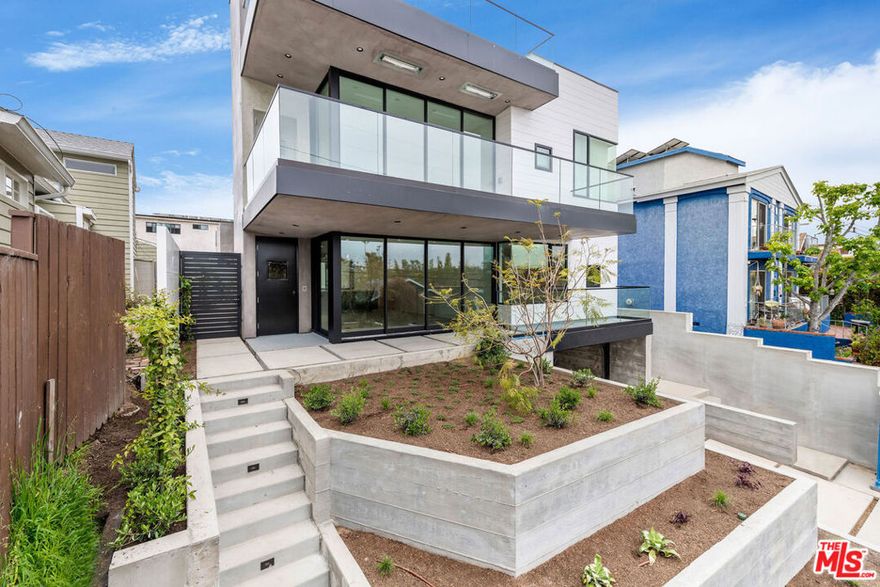 Experience modern living at its finest in this 2023-built duplex in the heart of Ocean Park, just minutes to Main Street, Rose Ave, and the beach. This sleek 3 bedroom, 2 bathroom unit left no stone unturned with luxury finishes, including motorized shades in every room, beautiful white oak hardwood floors throughout, and a Doorbird video monitor for convenient remote entry for guests. The open layout was thoughtfully designed with spacious rooms and oversized windows to allow for incredible natural light to flow through the space. The kitchen boasts a minimalist design, complete with handleless cabinetry, GE stainless steel appliances, and two peninsulas with breakfast bar seating. Fleetwood sliding doors open to the front patio and backyard (for exclusive use by Unit B), seamlessly blending the indoor and outdoor living spaces. Additional features include a central heating and air conditioning system with dual zones, whole-unit water filtration system, and solar panels to minimize your electric bill. An elevator takes you down to the enclosed community garage with two dedicated parking spaces for the unit, complete with a 220V outlet for electric car charging.