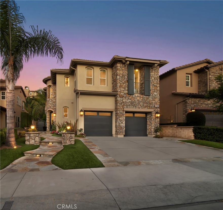 Gracefully set within the exclusive guard-gated community of San Joaquin Hills in Laguna Niguel, this home exudes sophistication and charm. From its stately stone façade and beautifully manicured landscaping to the warm glow of lantern-lit pathways, every detail creates a welcoming first impression.



Inside, elegant design elements such as crown molding, recessed lighting, plantation shutters, and custom window coverings create a refined and inviting atmosphere throughout. Formal living room features wood floors and a cozy fireplace, offering a comfortable space for gatherings.

White cabinetry, newer soft-close drawers, and marble countertops bring crisp sophistication to the newly upgraded kitchen, complemented by stainless steel appliances including brand new Thermador cooktop, steam oven, and dishwasher. At its center, a generous island flows seamlessly into a living room where a glowing fireplace sets the scene for connection and comfort.



Upstairs, the primary suite serves as a tranquil retreat framed by peaceful treetop views. Dual vanities, a soaking tub, and a spacious walk-in closet highlight the spa-like bathroom, blending beauty with functionality. Three additional bedrooms, versatile loft, and dedicated media room with custom built-ins provide ample space for relaxation, work, and play.



Designed for effortless enjoyment, the low-maintenance backyard offers a patio set before an outdoor fireplace, creating a perfect space for gatherings or quiet evenings. Completing the home is a two-car garage with newer garage doors (2022). Additional highlights include PEX plumbing, seller-owned solar, NUVO water filter system, newer water heater (2025), and two newer condensing units (2023).



Residents of San Joaquin Hills enjoy resort-style amenities, including two sparkling pools and spas, basketball courts, playgrounds, and scenic greenbelts. Ideally located near top-rated schools such as Aliso Niguel High School, as well as upscale shopping, fine dining, pristine beaches, and the 73 freeway.