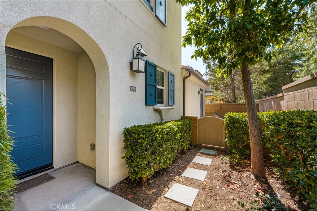 Welcome to 228 Borrego, an upgraded end-unit smart home in the desirable Agave enclave of Portola Springs. This tri-level residence offers a perfect balance of luxury and functionality with 3 spacious bedrooms and 3 full bathrooms, including a private suite on the main level ideal for guests or a home office. The open-concept layout features a chef-inspired kitchen with granite countertops, custom cabinetry, and high-end Bespoke Samsung appliances, seamlessly flowing into the bright and airy living and dining areas. Rich hardwood floors, abundant natural light, and custom window treatments elevate the space, while smart home features, an EV charging station, central heating and cooling, and in-unit laundry add comfort and convenience. The primary suite boasts a large walk-in closet and a spa-like bathroom, and the private patio is perfect for outdoor dining or relaxing. With an attached two-car garage and access to resort-style amenities including pools, parks, and scenic trails, plus proximity to the Great Park, Irvine Spectrum, Woodbury Town Center, and top-rated Irvine schools, this home offers an exceptional lifestyle in one of Southern California’s most sought-after communities.