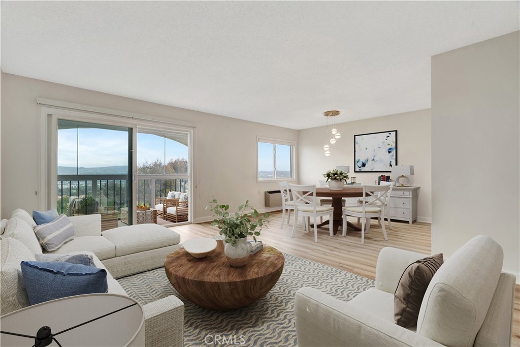SPECTACULAR PANORAMIC VIEWS! Enjoy resort-style living in this newly remodeled 1 BDRM/2 BA penthouse with stunning views in the 55+ community of Laguna Woods. This top-floor unit is immaculate with brand-new engineered wood flooring, fresh paint and baseboards. Enclosed view deck offers an unobstructed view of Saddleback Valley (daytime) and city lights from a direction that rarely comes on the market. Light and bright living area is spacious and there is a separate dining room, both with gorgeous views. The kitchen has newly painted white cabinets, upgraded Bosch dishwasher and newer range/oven. The primary suite has lush tree views, long mirrored closets and bathroom with a single vanity and newer reglazed tub and shower. Dual paned windows throughout. This unit is located in the exclusive hilltop Gate 14 section of Laguna Woods. The three-level building includes an elevator along with convenient laundry rooms on each level located just steps away from the unit. Trash chute is also located on the 3rd level. Nearby covered carport with additional storage. Minutes away from world-class restaurants and shopping in Laguna Beach. Enjoy views of city lights every night, Disneyland fireworks and snow capped mountains in the winter. Laguna Woods is a 55+ community with a 27-hole championship golf course, 7 clubhouses, 5 pools, 3 fitness centers, pickleball courts, wood and metal shops, arts and crafts, tennis, stables and over 250 clubs plus transportation system.