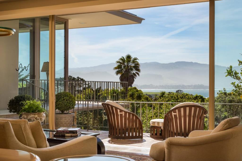 Landmark Pebble Beach estate with sweeping golf course and ocean views, ideal for watching the sunrise over the Santa Lucia Mountains. This mid-century modern home, filled with natural light, is abundant in space and luxury with 4 bedroom suites, 6 full baths and 1 half bath, a game room, lower level caretaker's apartment, sun room, safe room, outdoor fireplace area, and a show-stopping bar area. Upon entry, this Germano Milono designed floor plan is ideal for entertaining, overlooking the sparkling water and sands of the Pebble Beach golf course, Stillwater Cove and Carmel Beach. Each bedroom suite offers privacy and character with custom built-ins and spacious en-suite bathrooms. Equipped with a 3 car garage and ample space for additional parking, lush landscaping and terraces abound on this 1-acre lot in an absolutely unbeatable location.