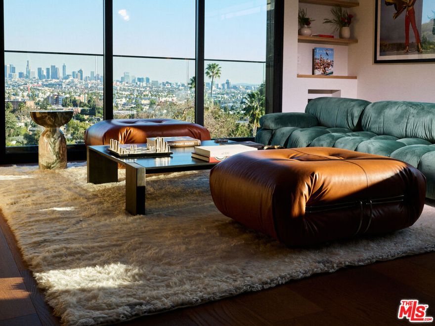 Tucked away in the exclusive Hollywood Hills, this private retreat seamlessly blends Old Hollywood glamour with modern luxury. Just minutes from the iconic Hollywood Sign, top studios, and world-class dining, it offers the perfect balance of seclusion and convenience. Designed with exquisite craftsmanship, the home showcases top-of-the-line finishes, including Brazilian woodwork, Italian marble, and bespoke wood cladding, plus a smart home system, creating an atmosphere of timeless sophistication. Expansive windows flood the space with natural light while framing breathtaking views. The main house features two bedrooms and 2.5 baths, while a detached bonus room serves as a versatile third space with its own bath, ideal for guests or a creative studio. Outside, the beautifully designed oasis invites effortless entertaining with a sparkling salt water heated pool, spa, fire pit, built in BBQ area, 2 car garage, all set against the backdrop of the serene Hollywood Hills. A true masterpiece, where classic elegance meets contemporary tranquility.