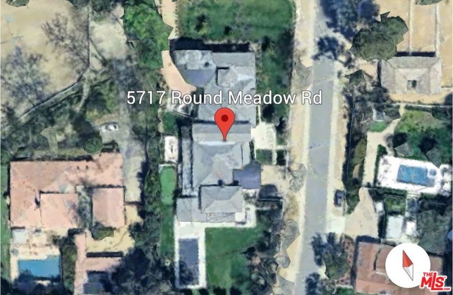 Experience unrivaled luxury in this one-of-a-kind Hidden Hills estate, a true architectural masterpiece offering nearly 11,000 square feet of refined living space on over an acre of lush, landscaped grounds. Primarily single-level in design, the home blends modern sophistication with effortless comfort through an open floor plan and soaring wood-paneled ceilings that create an atmosphere of grandeur.The residence boasts an array of world-class amenities, including a state-of-the-art theater, a vast primary suite with dual walk-in closets and baths, and a private wing designed as a serene retreat. Every detail reflects a commitment to elegance and quality, from the finishes to the thoughtfully curated spaces.For automotive enthusiasts, a subterranean garage accommodates up to 10 vehicles, complete with a viewing window from the expansive downstairs gym or office. Additional features include ensuite guest quarters, as well as a detached guest house with its own private entrance for ultimate privacy.Outdoors, the property transforms into a private resort with manicured lawns, a putting green, two fire pits, a swimmer's pool, and a fully equipped outdoor kitchen ideal for both intimate relaxation and grand-scale entertaining.This reimagined estate redefines Hidden Hills living, offering the perfect harmony of sophistication, comfort, and exclusivity. A true sanctuary, it awaits the most discerning homeowner ready to embrace the pinnacle of luxury living.