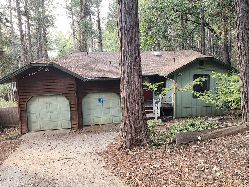 Discover this inviting 3-bedroom, 2-bath home (with potential for a 4th bedroom or bonus family room) set on a private 0.41-acre lot in Magalia. Enjoy the incredible views, mature trees, and large level fenced backyard with lush landscaping, a separate deck perfect for a hot tub, and both a lower covered deck and an upper balcony. Inside, the spacious master suite is on the main level and features a beautifully tiled shower. Upstairs are two additional bedrooms plus a full bath. Cozy up with either the pellet stove in the downstairs family room or the wood stove in the upstairs living room. The home includes a 2-car attached garage, underground power, and major appliances: Whirlpool refrigerator, GE washer/dryer, and propane gas range.
This property backs up to the Paradise Pines Property Owners Association—different from a traditional HOA—with low annual dues ($315) and exceptional amenities. Residents enjoy a pool, spa, clubhouse with classes, pickleball, billiards, trails, and more, plus an 18-hole disc golf course within the community. Built in 1986 with 1,634 sq. ft., this home offers space, privacy, and access to a vibrant neighborhood lifestyle.