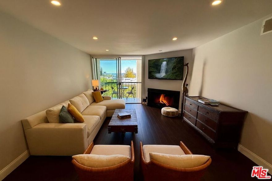 Welcome to Holloway Terrace #318  a fully furnished, designer 1 bed | 1 bath condo offering breathtaking views from a spacious terrace, modern updates, and a peaceful back-facing location in the heart of West Hollywood. This bright, stylish residence features luxury vinyl plank floors, a sleek kitchen with quartz countertops and stainless steel appliances, a cozy fireplace, and a private balcony perfect for morning coffee or sunset dining. The home's idyllic layout is elevated by chic wainscoting along the living quarters, adding texture and sophistication throughout. Enjoy resort-style amenities including a heated pool & spa, fitness center, recreation room, and rooftop sundeck with panoramic city views. Available short- or mid-term, this turnkey retreat includes central A/C & heat, a Nest thermostat, digital keypad entry, and gated parking - all just steps from Erewhon, Trader Joe's, SoHo House, Equinox, and the Sunset Strip. Your modern, equipped West Hollywood escape awaits!