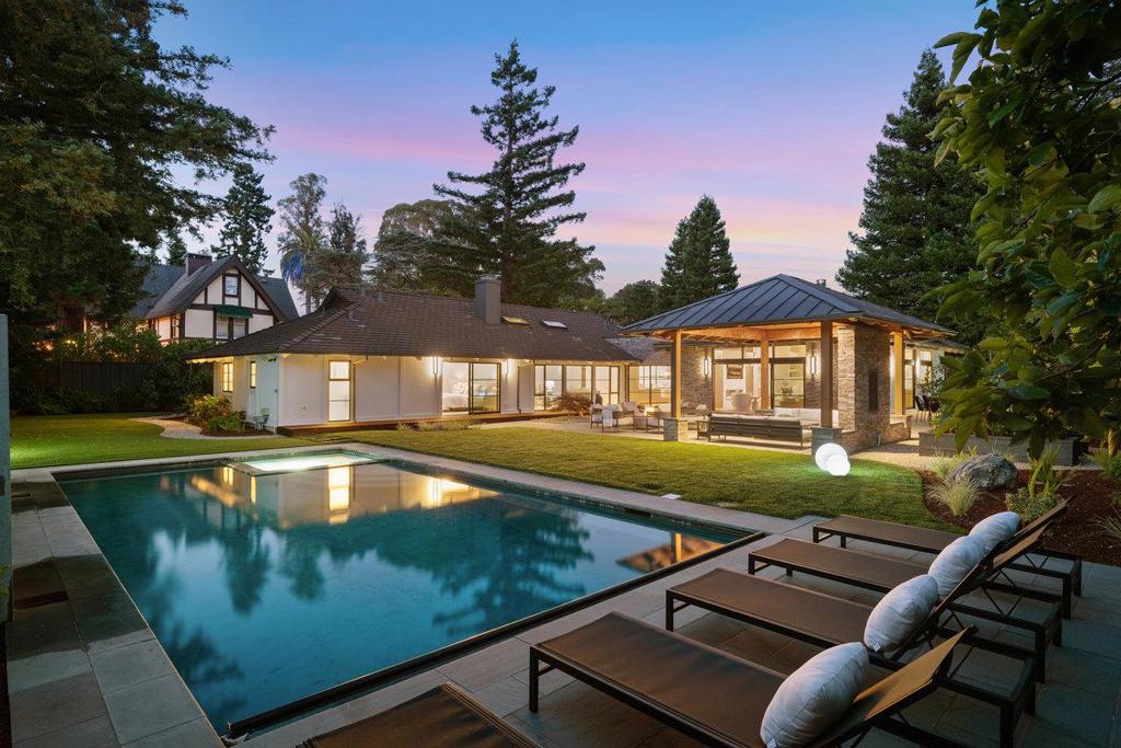 Privately situated at the end of a gated cul-de-sac, this beautifully remodeled home offers the rare combination of complete privacy and accessibility. Set just 0.2 miles from Downtown Burlingame, it is the only Hillsborough home on the market with such close proximity to Burlingame Avenue less than five minutes (+/-) from fine dining, shopping, cafes, and local events. Families will also appreciate the quick access to top-rated North and Crocker Schools, Burlingame High, Crocker Fields and Tennis Courts, and the Burlingame Country Club. Inside, soaring ceilings, Fleetwood doors, skylights, and engineered wood floors set a sophisticated tone. The chefs kitchen features Wolf, Gaggenau, and Sub-Zero appliances, a marble island, and custom Segale Brothers cabinetry connecting seamlessly to both formal and casual living areas. Five bedrooms are located along a skylit hallway, including a serene primary suite with backyard access, spa-style bath, and fitted walk-in closet. Outdoors, enjoy a custom pool and spa, water features and a fully equipped pavilion with heat, lighting, and AV. A turf and grass lawn, mature trees, and curated plantings complete the backyard retreat. Additional highlights include multiple fireplaces, a mudroom/laundry room, and a 2-car garage.