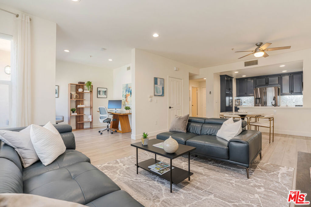 Welcome to your dream home in the incredible Tempo community of Playa Vista! This beautifully upgraded, top-floor 2-bedroom + den home offers a modern open layout, designer finishes, and an abundance of natural light. The entertainer's kitchen features striking deep blue cabinetry, sleek quartz countertops, stainless steel appliances, and convenient bar seating perfect for casual dining or gathering with friends. The kitchen seamlessly flows into the dining area and airy living space, creating an ideal setting for both relaxing and entertaining. Just off the living room, you'll find a versatile flex space, ideal as a home office, den, or creative nook - along with a private balcony where you can enjoy your morning coffee or evening breeze. Downstairs, both bedrooms offer ensuite layouts for maximum privacy and comfort. The spacious primary suite has a walk-in closet and a spa-inspired bathroom with dual vanities, quartz counters, a soaking tub, and a separate shower. The secondary bedroom also features an ensuite bath and a generous storage area. A full-size laundry area is conveniently located between the bedrooms. Additional highlights include two side-by-side parking spaces and access to Playa Vista's world-class amenities including The Resort gym and pool, and the CenterPointe Club. Located just steps from Concert Park, The Runway shops and restaurants, Playa Vista Elementary, the library, and local parks you'll love the walkability and vibrant lifestyle this community offers.