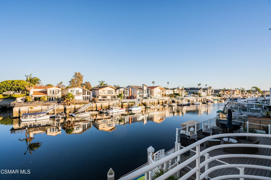 Don't miss this incredible opportunity to own a fully furnished, turnkey waterfront home in the heart of Mandalay Bay! This stylish, remodeled corner dock property offers direct access to the Channel Islands and the best of coastal living, all with no Mello-Roos or dock fees.Step upstairs and discover the heart of the home. The sun-drenched great room is perfectly suited for entertaining, boasting vaulted ceilings, multiple skylights, a beautifully updated fireplace, and sliding glass doors that open to a generous deck with captivating views of the waterway.The chef's kitchen is both stylish and functional, complete with granite countertops, stainless steel appliances, and a designer tile backsplash--perfect for hosting or everyday living. A versatile loft area provides the perfect space for a home office, reading nook, or guest accommodations.The primary suite offers a true private retreat experience. Modern Shoji-style doors separate the primary bedroom from the retreat living area with its own deck overlooking the serene channel. The spa-inspired en-suite bath includes dual rainfall showers, a Victorian soaking tub, and upscale finishes for a luxurious escape. On the first floor, a fully self-contained layout features two bedrooms, two full bathrooms, a sleek kitchenette, and a spacious family room that opens to a large waterside patio. With its own entrance, this level is ideal for extended family, guests, or potential rental income.The 30-foot private dock with 40-foot easement places boating, paddleboarding, and kayaking right at your doorstep. Spend your weekends exploring the nearby Channel Islands or simply unwind in your own waterfront sanctuary.Located between Malibu and Santa Barbara, Mandalay Bay is a hidden gem and offers one of the smartest waterfront buys on the Southern California coast.This home checks every box! Location, design, versatility, and value. Whether you're seeking a full-time residence, vacation home, or investment property, this is a true waterfront deal that won't last. Seize this unbeatable value and claim your slice of coastal paradise today!