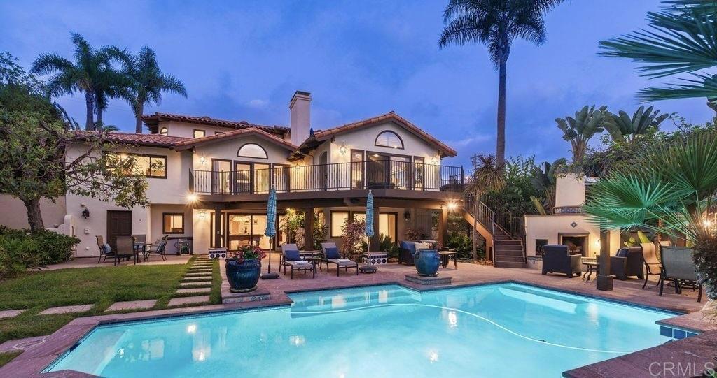 Elegant Mediterranean Villa with Riviera-Style Ambiance in Cardiff’s Coveted Composer District! This residence offers ocean views, lush gardens, pool/jacuzzi with waterfall features. Timeless Architectural Highlights: stone columns flank the double door entry that opens to soaring ceilings, oversized crown molding. Dramatic staircase with wrought iron railings & wood plank steps lead to the mezzanine with ocean views & the soaring entry area...other highlights include art niches and perfectly placed windows bringing in natural light. The rich wood plank floors and tumbled travertine stone offers warmth and elegance. Main floor living offers stone surround fireplaces, open beam ceiling, custom cabinetry and arched windows. The Formal Dining Room is next to the custom designed kitchen, with abundant granite countertop, glass front cabinetry w/ custom hardware and high end appliances. The heart of the home kitchen opens to the family room with open beam ceilings, built in entertainment wall (find the seahorse handles!) Sliding glass door leads to an entertainment deck perfect for indoor outdoor entertaining and a staircase to the pool and gardens. The main floor has a guest bedroom with a charming bay window seat near main level bathroom. Upstairs off the mezzanine is the spacious primary suite and deck with amazing ocean and coastline views. The suite includes a luxurious primary bath plus a large customized walk-in closet. Downstairs are two bedrooms with walk-in closets sharing a Hollywood Jack & Jill bath...Billiards/Game room w/fireplace, and a built-in office area, temperature controlled Wine Cellar plus a full bath & laundry room.... private resort backyard w/ fireplace, outdoor kitchen with BBQ, and a charming trellis covered dining area surrounded by mature palms and birds of paradise.