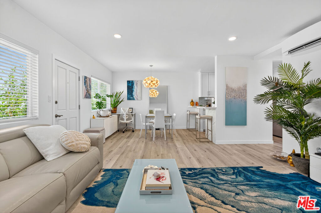 Welcome to this beautifully reimagined, top-floor condo offering 884 sq ft of thoughtfully curated living space in the heart of Santa Monica. Completely remodeled from top to bottom, this bright and airy 1BD/1BA retreat combines luxury, comfort, and convenience just moments from Montana Avenue, the 3rd Street Promenade, Farmer's Market and iconic beaches. Step inside to an open floor plan featuring recessed, WiFi-enabled LED lighting and luxury vinyl plank flooring throughout. Beneath it all, soundproofing panels ensure your home remains a peaceful sanctuary. New double-paned, UV-protected windows offer energy efficiency and quiet comfort. The sleek, modern kitchen is a showstopper with waterfall-edge quartz countertops, bar seating, double stainless-steel sink with touchless faucet, and Energy Star appliances, perfect for the home chef and entertaining. The spa-inspired bathroom features an ergonomic 22" deep Jacuzzi soaking tub, Toto Japanese toilet, and an illuminated Kohler vanity cabinet. Custom floor-to-ceiling hallway closets and a spacious walk-in with a mirrored sliding door provide ample storage. Two Daikin mini-split systems (permitted and HOA-approved) offer zoned A/C, heat, and fan control, including a Three Stage (including HEPA) Filtration System, in both the living and bedroom areas.Step out onto your exclusive, sun-drenched patio ideal for morning coffee or sunset relaxation with potential for in-unit washer/dryer installation. This unit also includes assigned 1-car parking and a large private storage area. A rare blend of tranquility and urban convenience, this turnkey Santa Monica gem is ready to welcome you home. Also available fully furnished - Inquire with the listing team.