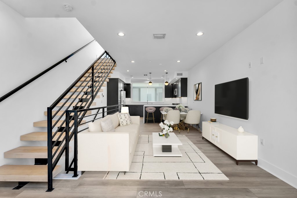 This modern and stylish 3-bedroom, 3-bathroom townhome offers 1,624 sq ft of living space in a newer North Hollywood complex. The open-concept main level showcases a sleek kitchen with stainless steel appliances, a spacious living area, and access to a private balcony, perfect for indoor-outdoor living. Upstairs, the expansive primary suite features a luxurious double-sink en-suite bath, walk-in closet, and a large private balcony. The lower level includes a junior suite with its own en-suite bath and a third bedroom with a nearby full bath. Additional highlights include a private front yard, central HVAC, in-unit laundry, recessed lighting, dual-pane windows, and a versatile bonus room off the attached 2-car tandem garage that is ideal for a home office, gym, or extra storage. Conveniently located near NOHO West, the Arts District, Burbank Airport, and major freeways, this move-in-ready home offers modern comfort in a prime location.