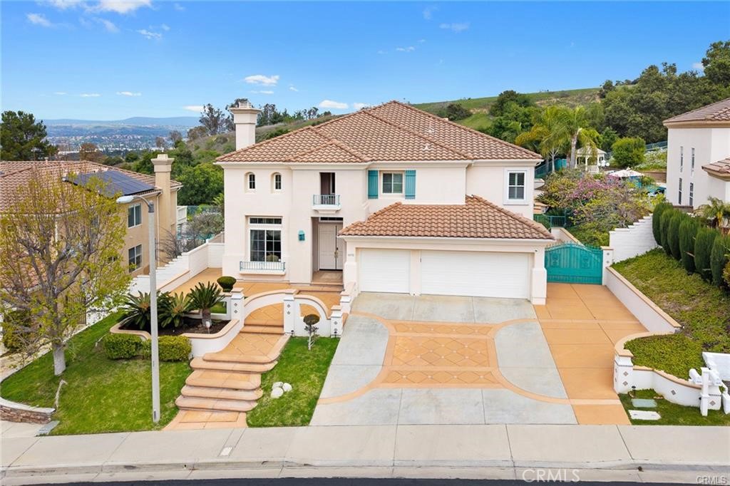 View, view, view. Breathtaking city lights and snow caps in winter, and offer one-of-a-kind viewing points of the sparking city lights by night. Nestled in Rowland Heights primer residential corridor "Ridgemoor" community with 24 hours security guard. Total 7 bedrooms, 5.5 bathrooms (4 suite) An elegant grand foyer entrance with beautiful double doors, and crystal chandelier makes the centerpiece of this home welcoming point. Elegant living room with extremely high ceilings, fireplace, and open to the formal dining room with crystal chandelier. The spacious family room features custom built-in bookshelves. Stunning kitchen space with large island, granite countertops, built-in appliances and separate wok kitchen, two suite and powder room on the main floor. Spacious and luxurious upstairs primary bedroom suite with balcony which can overlook the breeze view and offers two large walk-in closets. Primary bathrooms feature dual vanities, bathtub and separate shower. Other 4 bedrooms and 2 bathrooms on the second floor. One suite is spacious customs tatami floor. Professional landscaping features a sparking swimming pool and spa. Built-in BBQ, patio, Gazebo, and putting green. Rest and relax in an open-concept backyard, perfect for entertaining. Very convenient location close to school, shopping center, bank, restaurant.