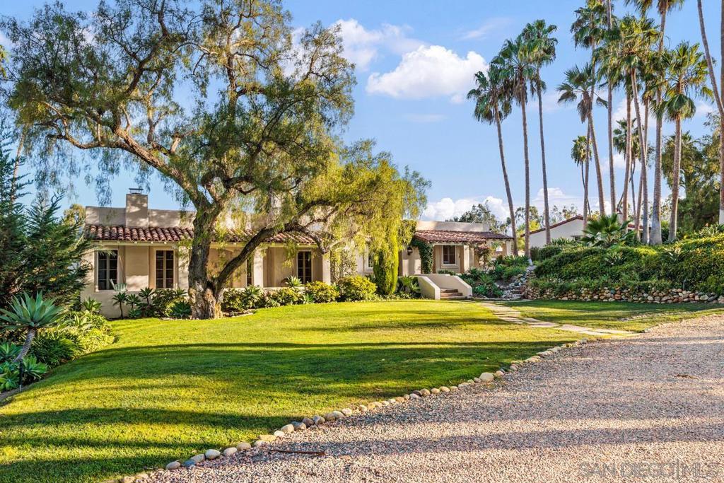 Capture the essence of Rancho Santa Fe in this iconic Holcombe designed compound built in 1999 w/primary living on a Single Level. Built to amaze and frequented by VIPS as mentioned in Katie Couric's new book. Outdoor kitchens, bar, pool/spa and a 2bd guest house surround the 3+ acre park like setting with a "Secret Garden" created by renowned landscape architect KATE SESSIONS. Peaceful and serene blend of indoor/outdoor living with big views! Secluded, but minutes to the Village of RSF and to the beach! It's a world of your own as you enter the gates and down a long crushed gravel driveway shaded by massive eucalyptus trees, leading to a 3.3 acre park like setting within the Covenant of Rancho Santa Fe. This Holcombe masterpiece blends indoor/outdoor living with old world architecture and now modern elements, incl. newer Calacatta slab marble countertops, custom cabinets, Wolf and Sub Zero appliances, water filtration system, a farm sink and a pizza oven. The main level has an expansive Primary Retreat with several wings incl. two separate Newer spa bathrooms for his and hers sides, incredible built in custom closets, a separate ensuite office/library/yoga room and private covered terrace to relax and soak in the views. Across from the master retreat is an atrium leading to 2 additional ensuite bedrooms on the main level. The lower level of the home has a Billiards Room, Large Gym, Office Space, 2 ensuite bedrooms, a large half bath, Wine Cellar, Kitchen area, Game Room and a huge closet/storage room. An 820 square foot 2-bedroom Guest House has a it's own entrance, 2 patios, living room, 2 fireplaces, laundry, newer bathroom with a walk in shower, kitchen and bar area. Spectacular mountain views and overlooking the property and "Secret Garden". The saltwater pool/spa has cover for security, keeping the water clean and warm. The pool house has a full bath, living room/fireplace, bocce ball for entertaining. There is an integrated security system, and OWNED SOLAR. Just minutes from the Village, RSF Golf Club & Course, beaches, and shopping, and the highly acclaimed Roger Rowe and Rancho Santa Fe Schools.