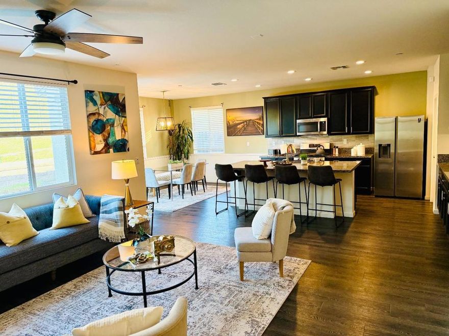 Welcome to this stunning 4-yr old one-story home offering 4 bedrooms and 2.5 baths designed for modern living. The spacious floor plan creates a seamless flow from the living room to the kitchen, highlighted by recessed lighting, high ceiling, gleaming laminate floors, and a bright airy ambiance. The chef's kitchen is both elegant and functional, featuring a large center island with granite countertop, ample cabinetry, generous pantry space and stainless steel appliances, perfect for cooking and entertaining. The dining room leads to the patio and backyard, ideal for family barbecue and weekend relaxation. The master's bedroom is a true retreat featuring a large walk-in closet, a spa-like bathroom with dual sink vanity, a soaking tub and separate shower. The beautiful finishes and thoughtful upgrades throughout make this home stand out, in addition to a tankless water heater and seller-owned solar panel for energy efficiency. This turn-key home combines comfort, functionality and sustainable living, a perfect blend for today's lifestyle.