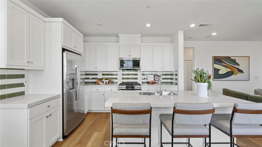 This new three-story home is host to a private den on the first level. On the second floor, an inviting open-concept layout is adjacent to a bedroom and full bathroom, with a deck offering convenient outdoor access. Two additional bedrooms can be found on the third floor, including the owner’s suite with an en-suite bathroom and walk-in closet.