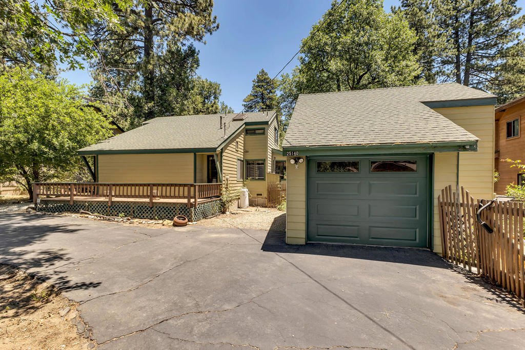Tucked at the edge of a serene meadow with peek-a-boo mountain views, this beautifully maintained home offers peace, privacy, and versatility. Step into the sunlit mud room which opens to the large living room with vaulted ceilings, skylights and a bright, open layout that flows into a charming wrap-around sunroom-perfect for enjoying the scenery year-round. The main level features two spacious bedrooms, a full bath, and a laundry room for convenient single-level living. Upstairs, discover a private office, additional bedroom and bath, ideal for guests or a quiet retreat.The detached 1-car garage includes a workshop and an unfinished upper level-ready to be transformed into an art studio, guest suite, or hobby space. Outdoors, enjoy both covered and open-air decks, a fully fenced yard for pets or gardening, and a newly sided exterior that adds fresh curb appeal. The circular driveway offers easy access year-round and located on a county-maintained road. A rare blend of natural beauty and creative opportunity-this home is a must-see for nature lovers, artists, and those seeking mountain tranquility.