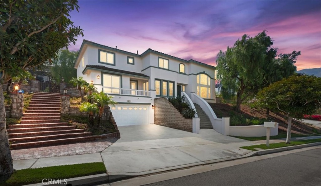 Welcome to this stunning custom-built residence nestled in the sought-after Sierra Del Oro community, just one freeway exit from Yorba Linda. Perfectly positioned with convenient access to Orange, Los Angeles, and Riverside Counties, this home combines modern updates with timeless craftsmanship for the best of luxury and convenience.
Spanning 3,872 sq ft, the home offers 5 bedrooms, 3.5 bathrooms, and a thoughtfully designed floor plan. Step inside to a grand entry with soaring ceilings that fill the space with natural light, leading into a bright living room anchored by a full-height arched window. A formal dining room, family room with fireplace, and a dedicated home office provide versatile spaces for every lifestyle. Recent renovations make this home truly move-in ready: brand-new SPC flooring throughout, freshly painted interior, updated kitchen cabinets, and new stainless steel appliances. The gourmet kitchen also features Corian countertops, a center island, and plenty of workspace for entertaining. A downstairs bedroom with its own full bath is ideal for guests or multi-generational living. Upstairs, the primary suite is a retreat of its own with a fireplace, dual walk-in closets, and a spa-inspired bath with a jetted soaking tub and separate shower. A dual staircase adds both elegance and convenience to the layout. The backyard is perfect for gatherings with a built-in BBQ island, professional landscaping, and ample room to add a pool. Additional highlights include fresh exterior paint and a spacious 3.5-car tandem garage. With recent upgrades, an unbeatable location, and the charm of Sierra Del Oro, this home offers the ideal combination of space, style, and functionality.