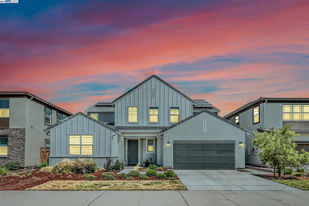 This modern River Islands home features 5 bedrooms and 4.5 baths. 3,275 sq ft of well-designed living space on a 6,090 sq ft lot. The open layout includes ceramic tile flooring and a gourmet kitchen with quartz countertops, stainless steel appliances, built-in oven and microwave, and upgraded cabinetry. A private in-law unit could be a possible rental income, with its own separate entrance, fridge, and laundry. This home offers flexibility for extended family or guests. The backyard is professionally finished for easy outdoor living, complete with a spacious California room, built-in BBQ, and a vegetable garden. Private lake access from the yard adds a quiet space to relax, especially during sunset. Owned solar and a water softener provide long-term savings and everyday comfort. The house is within walking distance to Epic Academy and close to River Islands High School.