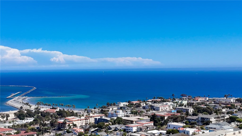 Welcome to the epitome of luxury coastal living! 4-bedroom, 3-bathroom ocean view condo is located in the highly desired Point Fermin area of San Pedro. Approx. 1,900 square feet home boasts massive ocean views from inside home & multiple outdoor patios & balconies. Open concept bright & airy top floor comes equipped with large kitchen, living room & large outdoor balcony w/stunning Ocean views to enjoy magical 4th of July fireworks, endless sunrises with the Pacific Ocean as the backdrop, plus distant views of Downtown LA & the harbor! Kitchen offers stainless steel refrigerator, microwave, dishwasher, double oven, dual sink basin, tons of storage space, ceiling-to-floor food pantry, 3-seat breakfast bar, granite counters, tile floors, tile backsplash & attached dining room! Living room offers prime Ocean view seating with cozy gas fireplace, wood floors, crown molding, large sliding doors for balcony access & a wet bar. Master bedroom is spacious & boasts Ocean views, 3 closets, balcony access, bathroom ensuite, mirrored sliding glass doors & wood floors! Home comes with approx. 100 square feet storage room w/built-in workshop, lighting, cabinets & storage shelves. 2 bedrooms have ocean views. 2 bedrooms can be transformed into an office, home gym, storage or additional guest bedrooms. One bedroom is currently being used as a media room & features built-in glass display cabinets & ocean views. Home fully equipped with radiant heating, easy care wood floors, walk-in tub with jetted spa, recessed lights, mirrored sliding closet doors, built-in cabinets, low maintenance laminate & tile floors, expansive closet space & plantation shutters. Home has large laundry room with washer, dryer, sink & more storage under staircase! Balconies are massive & you could add garden beds & furniture. Home features 2-car garage parking plus plentiful guest street parking. Home has two levels & is perfect for entertaining & lounging! Home & neighborhood are pet friendly with walk streets. Common area has elevators, ramp for wheelchair access, outside courtyard, BBQ area, treadmill, rec center & meeting room. Low HOA of $650/month includes building hazard insurance, common area electric, water, trash & gas. HOA is self-managed by homeowners. Residence near ocean walking paths, cafes, hiking trails, Cabrillo Beach, White Point Nature Preserve, Point Fermin Park, shopping, golf courses, banks, grocery stores, restaurants, marinas, parks, hospitals & the 110, 710 & 405 Freeways.