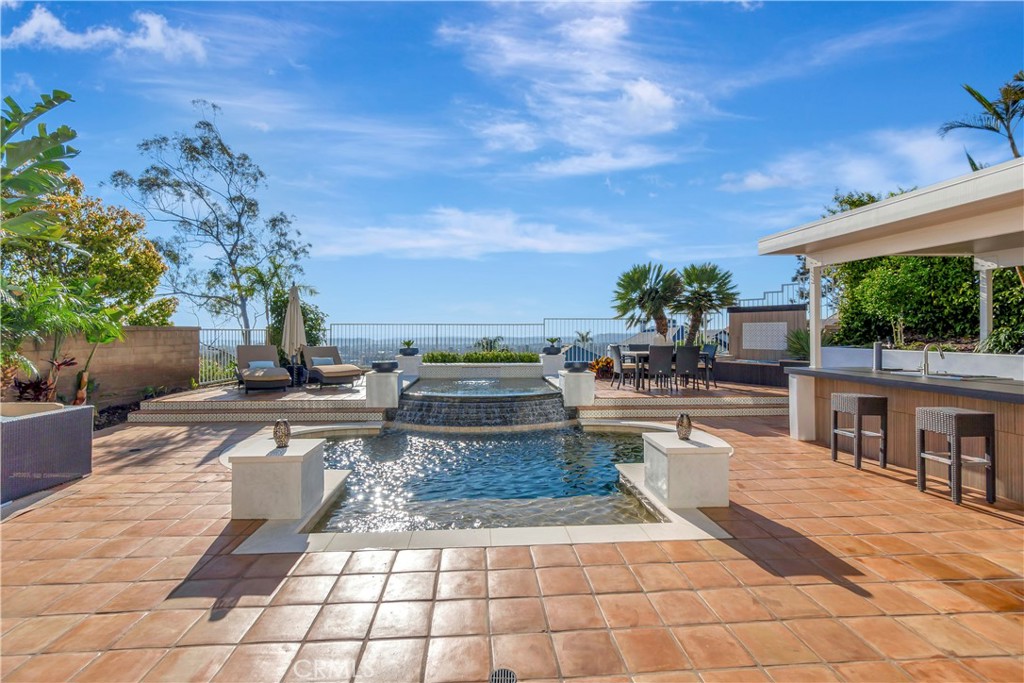 This is a rare opportunity to own a completely renovated 5-bedroom, 4-bath home in the private, gated community of Rancho Cielo—offering sweeping sunset and ocean views that stretch from Catalina to Rancho Palos Verdes. Watch 4th of July fireworks from your own hot tub, or unwind with a glass of wine as the sun dips below the horizon.
No expense was spared in the renovation. Every detail was thoughtfully executed—from high-end finishes to smart home features, including motorized shades throughout. The expansive open floor plan includes a gourmet kitchen, separate office, and an oversized Master Suite with spa-like bath and direct access to the backyard.
Step outside to your own resort: a saltwater pool with fountains, custom-built outdoor kitchen, and lush landscaping that offers true privacy. It’s an entertainer’s dream with a setting that’s second to none.
Residents of Rancho Cielo enjoy premium amenities including tennis courts, basketball court, playground, community pool, and direct access to scenic canyon trails and lakes. Top-rated public schools are nearby, and highly regarded private schools are within walking distance.
Luxury, privacy, and panoramic views—this is Southern California living at its finest. Homes in this hidden enclave rarely come to market. Don’t miss your chance.