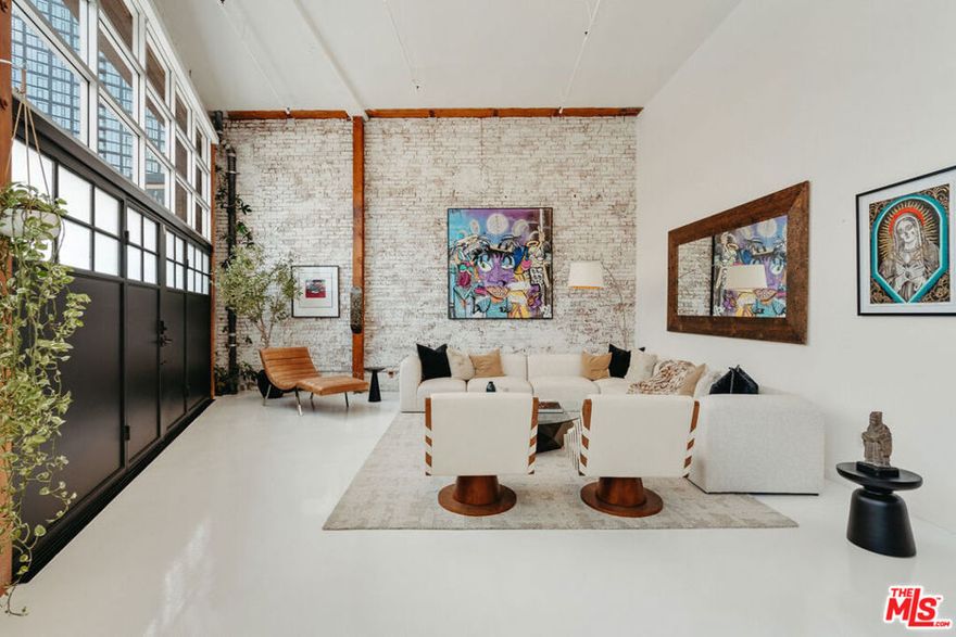 A rare opportunity to own a truly distinctive live/work loft in the heart of the Arts District - a space that perfectly blends creativity, comfort, and design. Originally renovated by a renowned film and television composer, this residence features a fully operational, soundproof recording studio built to professional standards ideal for music, film, or post-production work. Every element was crafted with precision and no expense spared, resulting in a space that's as functional as it is inspiring. Beyond the studio, the home offers a warm, livable layout anchored by a spacious master bedroom suite with built-in upper storage and the flexibility to be converted into a second studio if desired. The custom-built galley kitchen combines thoughtful design with quality finishes, making both everyday living and entertaining effortless. Additional highlights include 15.5-foot ceilings, original brick, post and beam accents, custom soundproofed steel entry doors and windows, power shades, and newly refinished white epoxy floors that lend a sleek, gallery-like atmosphere. A private street-level entrance with dedicated parking enhances both privacy and convenience. Set within the iconic Molino Street Lofts, a hallmark of 1920s warehouse architecture converted into 91 condominiums in 2006, residents enjoy two rooftop decks with city, building, and street views, a pool and BBQ area, and a fitness center. Surrounded by the creative pulse of the Arts District just steps from Hauser & Wirth, Manuela, Bavel, Verve Coffee, ROW DTLA, Soho House, local mural tours, Hank's Organic, the Arts District Dog Park, Damian, Bestia, Girl & the Goat, Urth Caffe, and more this vibrant neighborhood is also home to innovative companies such as Honey, BMG Music, 3sixteen, Soylent, Lucky Brand Jeans, and Spotify. This is an exceptional opportunity to own a true creative sanctuary and refined urban home.